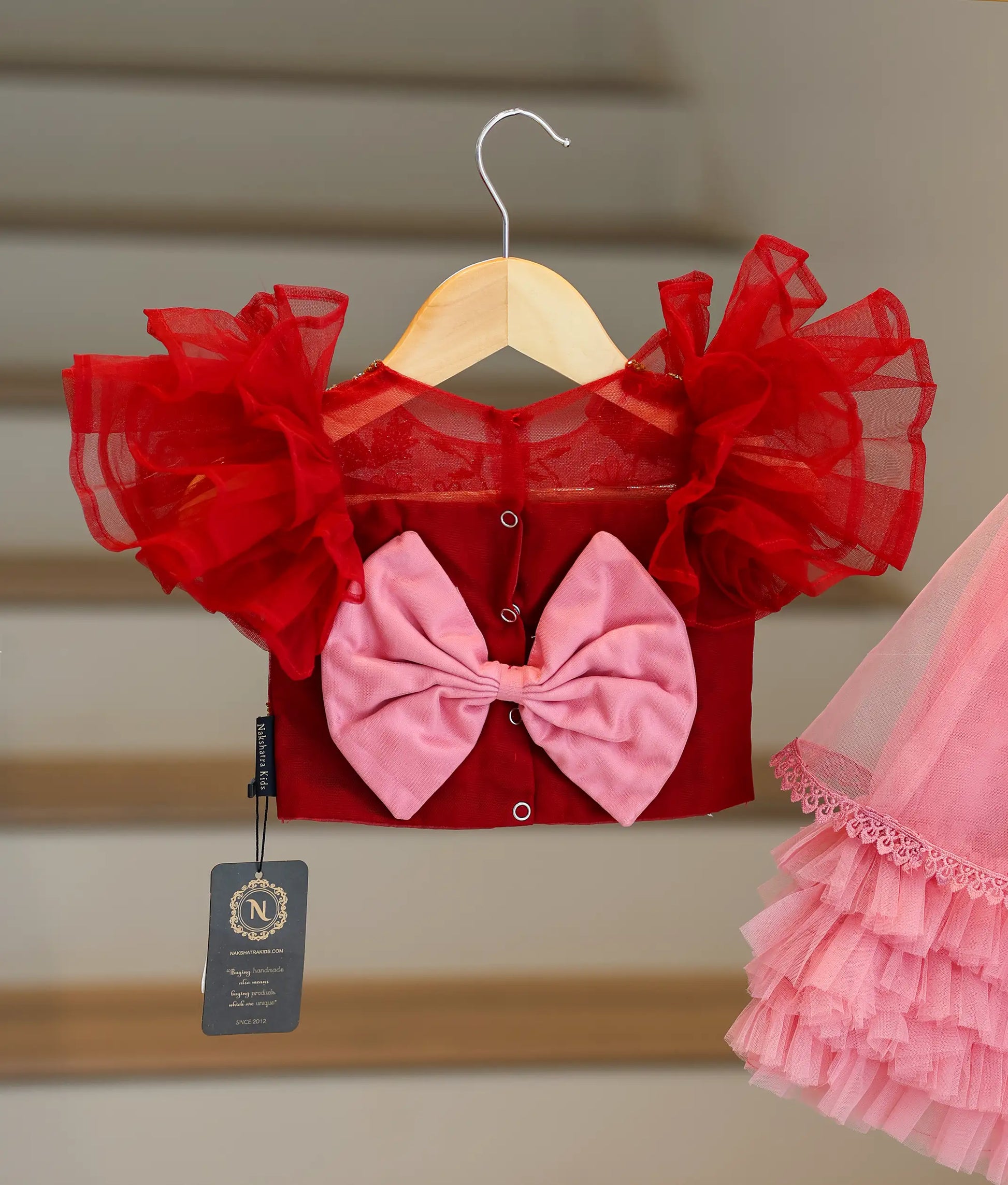 Back view of the maroon and onion pink set showing the round neck, press button, and decorative bow