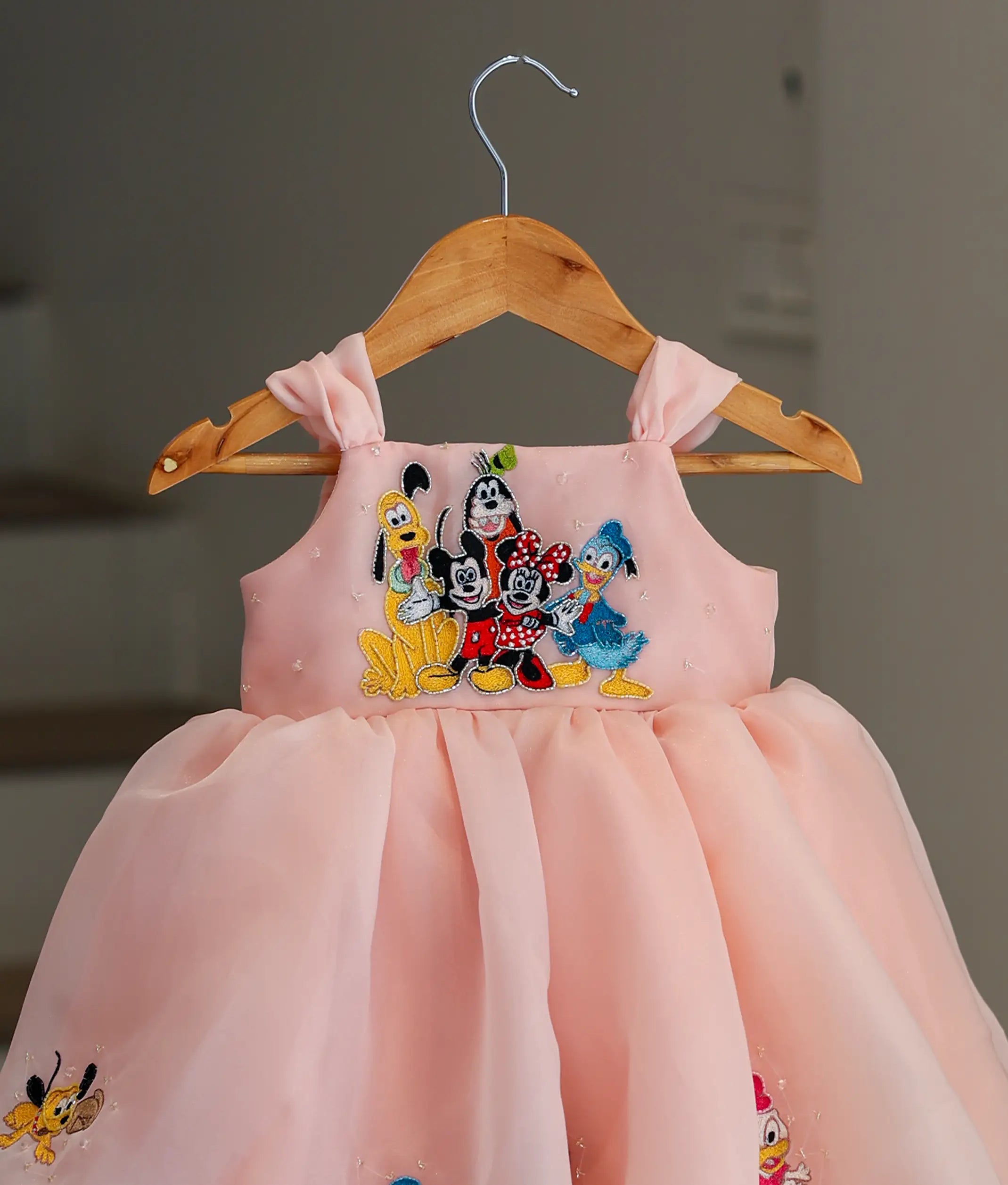 Close-up of the Mickey Mouse applique and handworked details on the bodice of the birthday frock