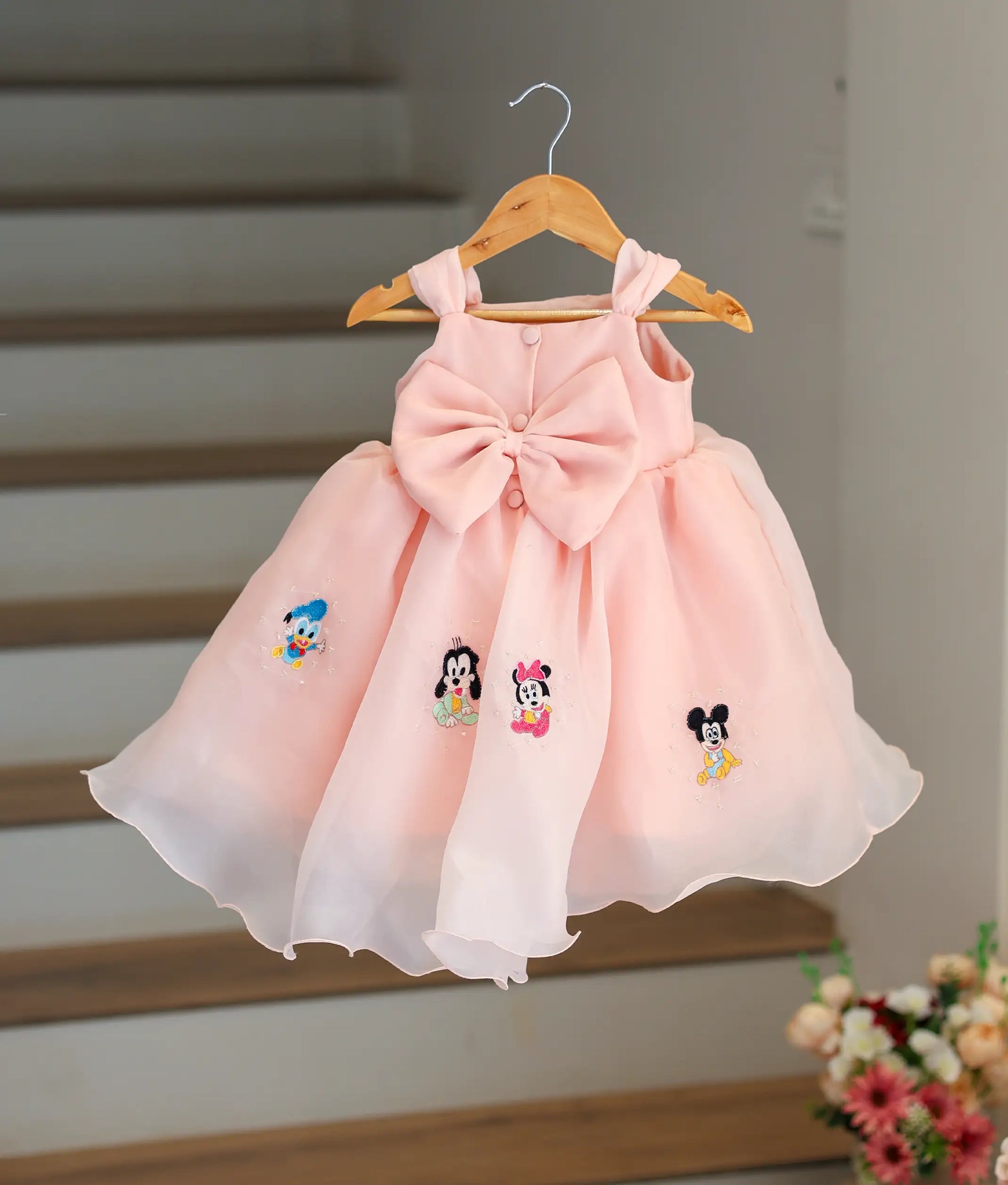 Back view of the Mickey Mouse theme dress showing the button closure and large decorative red bow