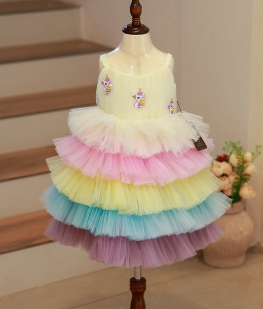 Front view of a multicolored unicorn-themed birthday frock with sequin and pearl detailing.