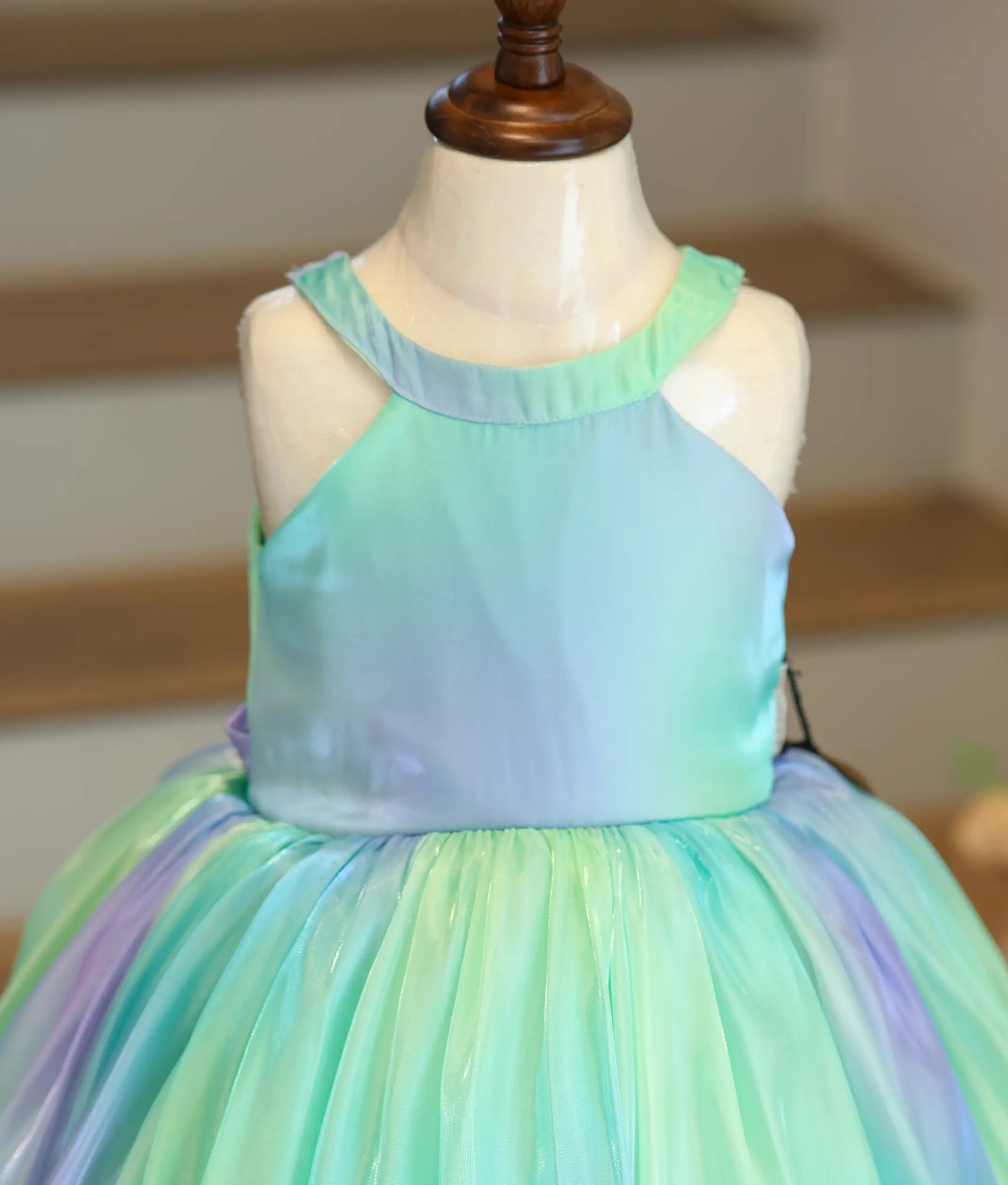 Close-up of the halter neck design and the vibrant green and pink multishade fabric.