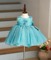 Front view of a Munsell blue girls' birthday frock with star-motif handwork and a multiple-layered tulle skirt