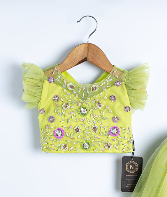 Close-up of neon green swan theme embroidered top showing handmade applique work in skirt and top set for baby girl