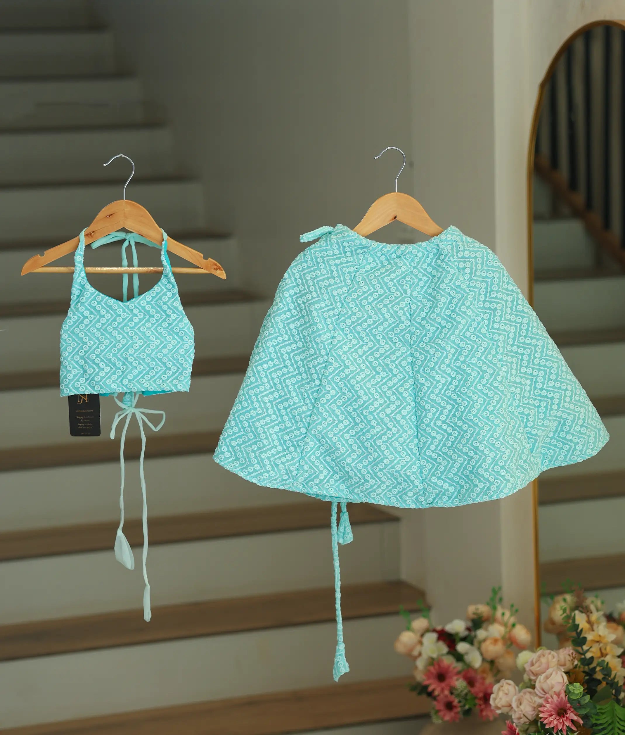 Front view of a baby girl wearing an occasion blue georgette skirt and top with a halter neckline