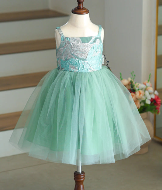 Front view of an ocean-green tulle net frock with a silver leaf-pattern turkish organza top.