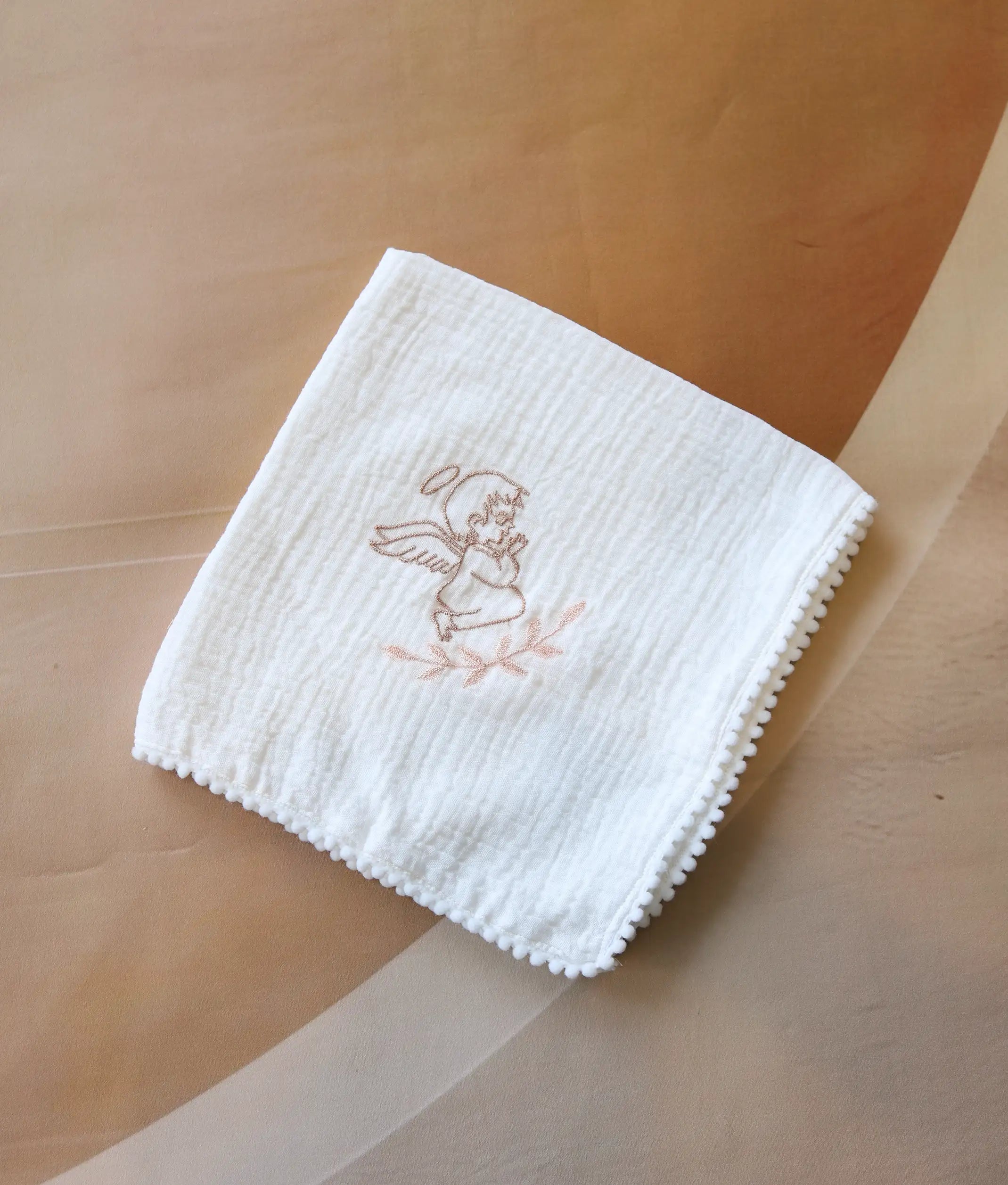 Front view of an off-white angel embroidery cotton baptism towel.