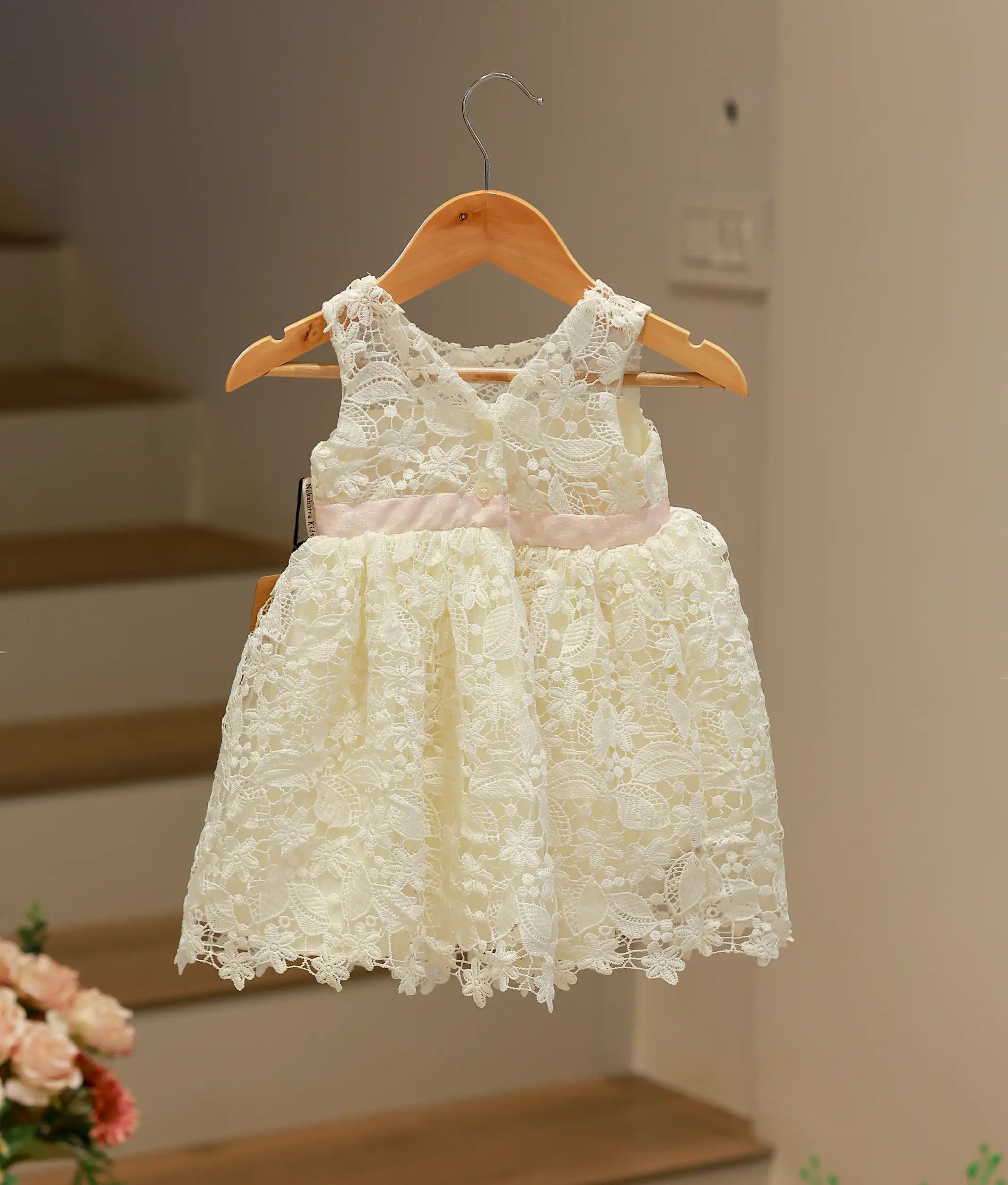 Back view of the off-white crochet baptism frock showing the comfortable fit and elegant rear finish