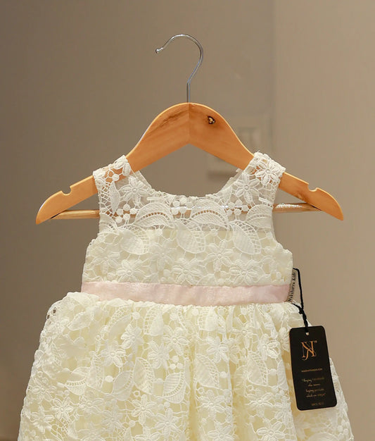 Close-up of the off-white baptism frock highlighting the intricate crochet knit patterns and delicate artisanal detailing