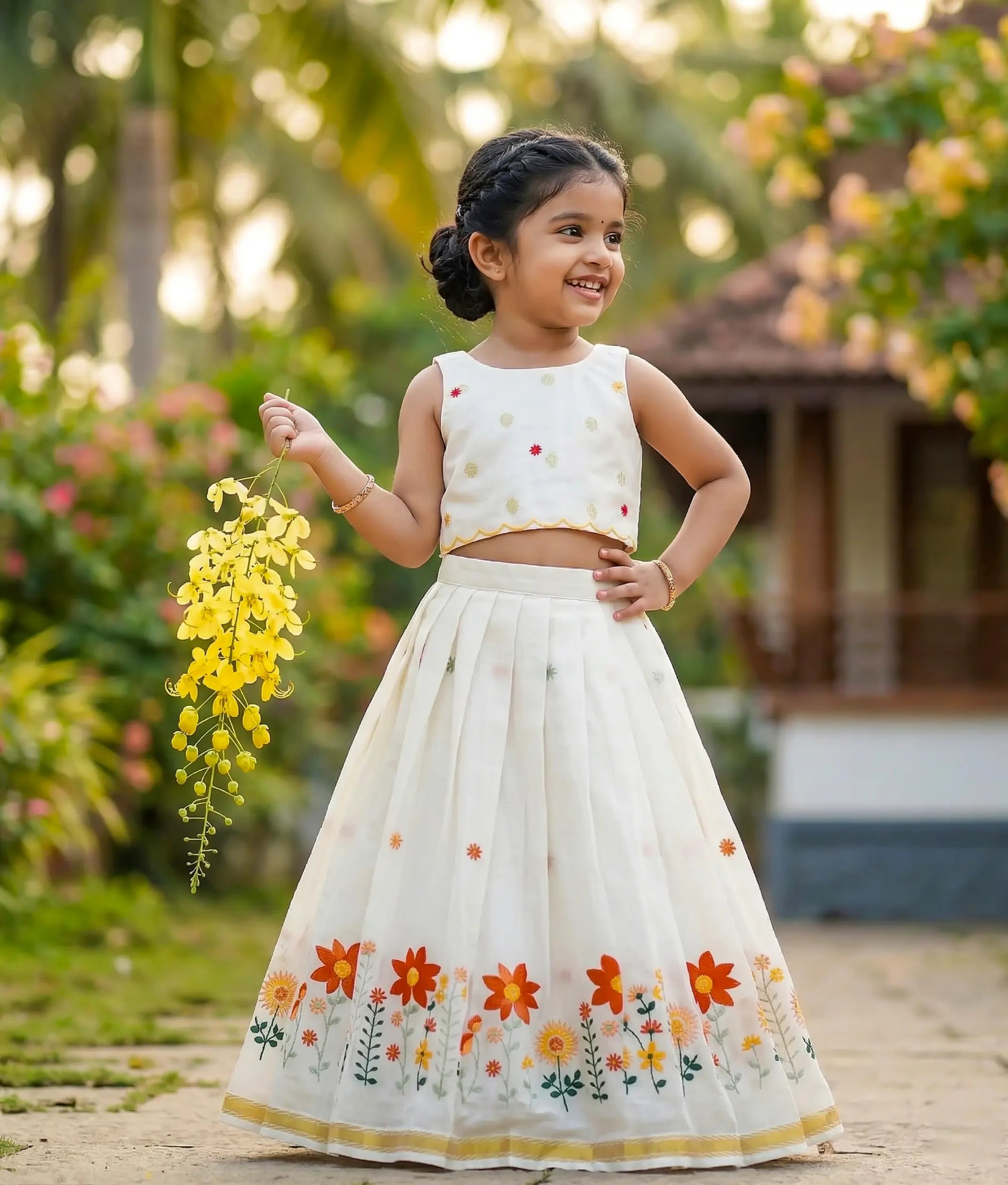 Baby girl wearing an ethnic floral embroidered skirt and top for vishu.