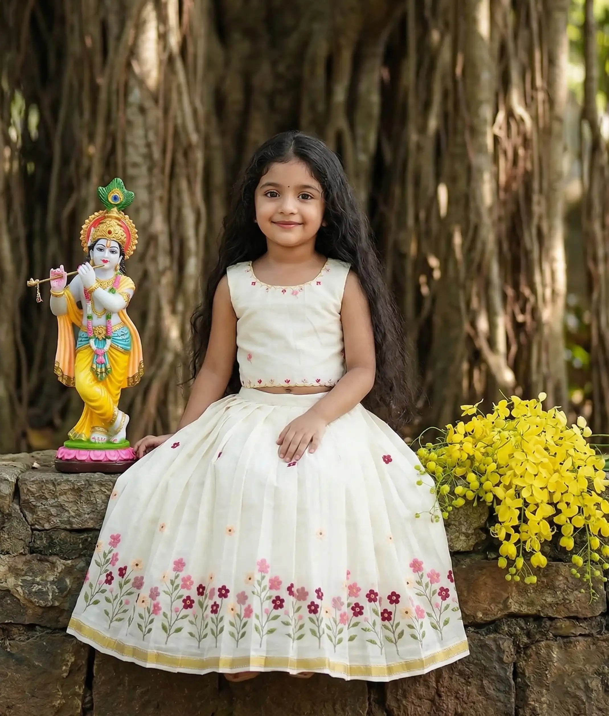 Baby girl wearing an ethnic floral embroidered skirt and top for vishu.