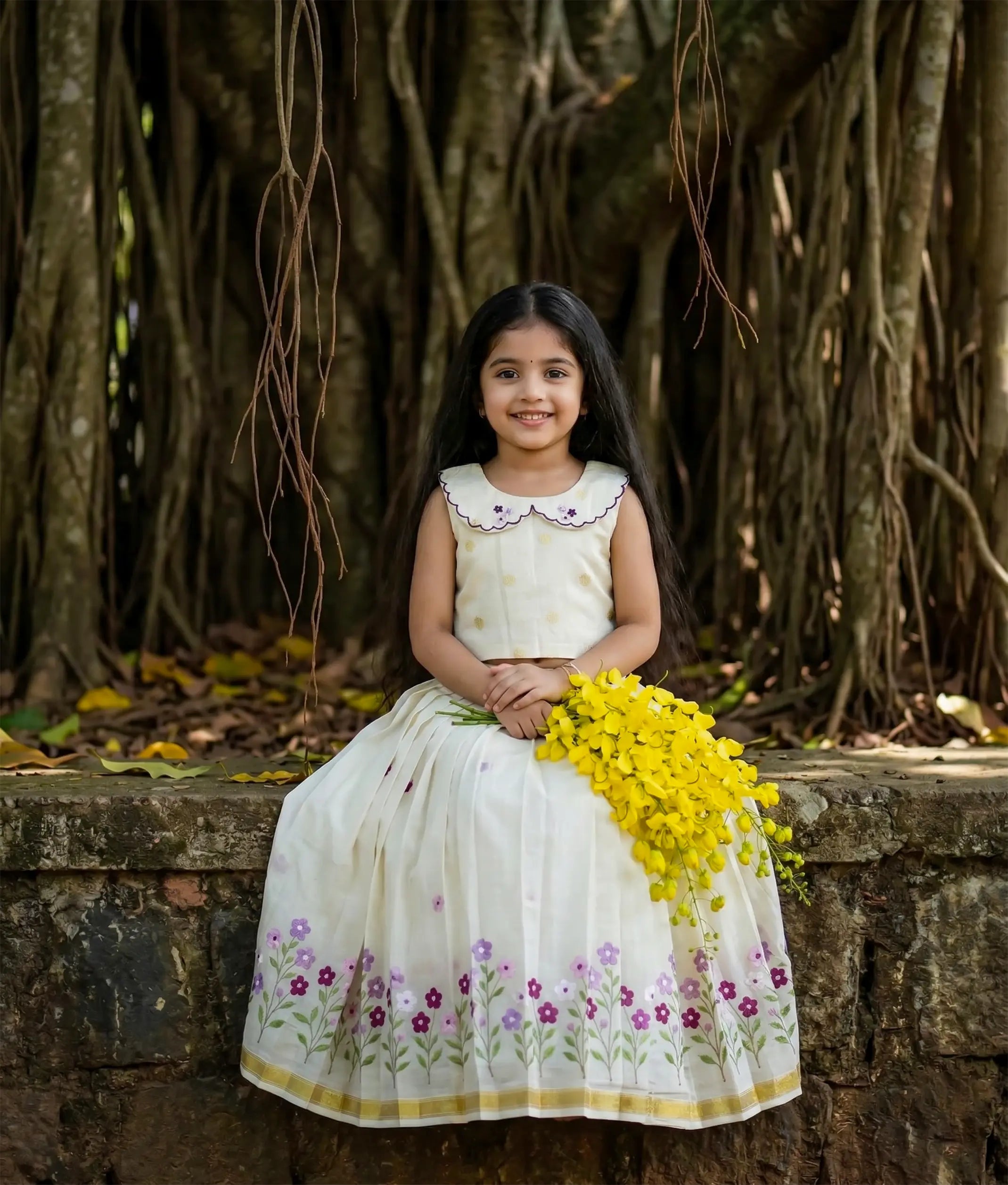 Baby girl wearing an ethnic floral embroidered skirt and top for vishu.