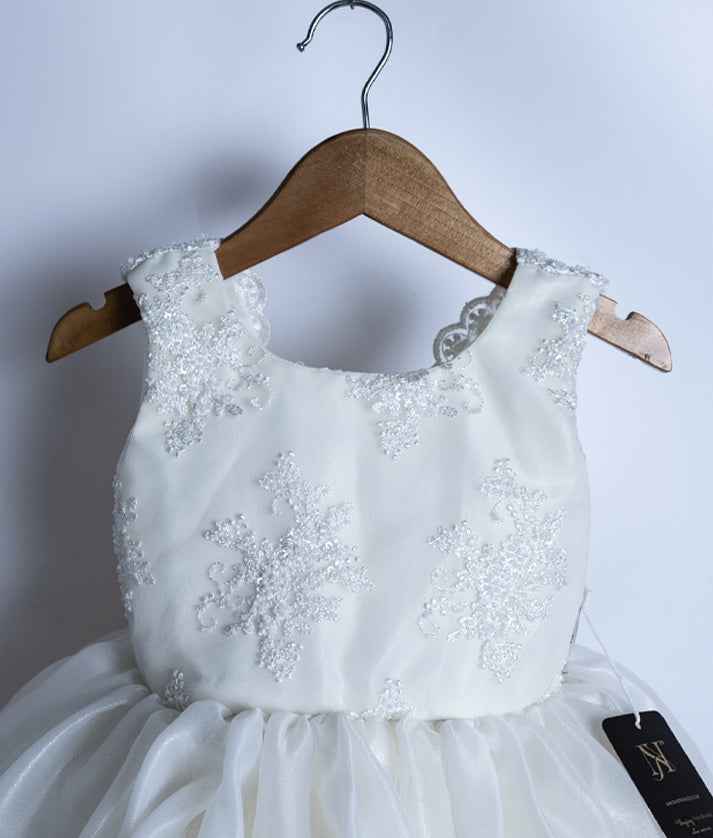 Close-up of the off-white frock showing the intricate floral embroidery on the shimmer organza top