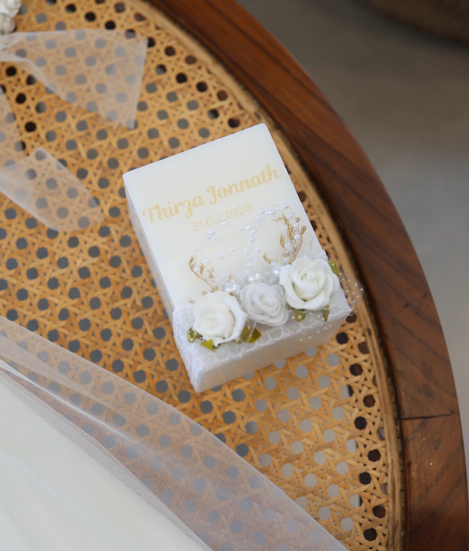 Square off-white personalized baptism candle for baby girl decorated with 3D white roses and delicate net trim.