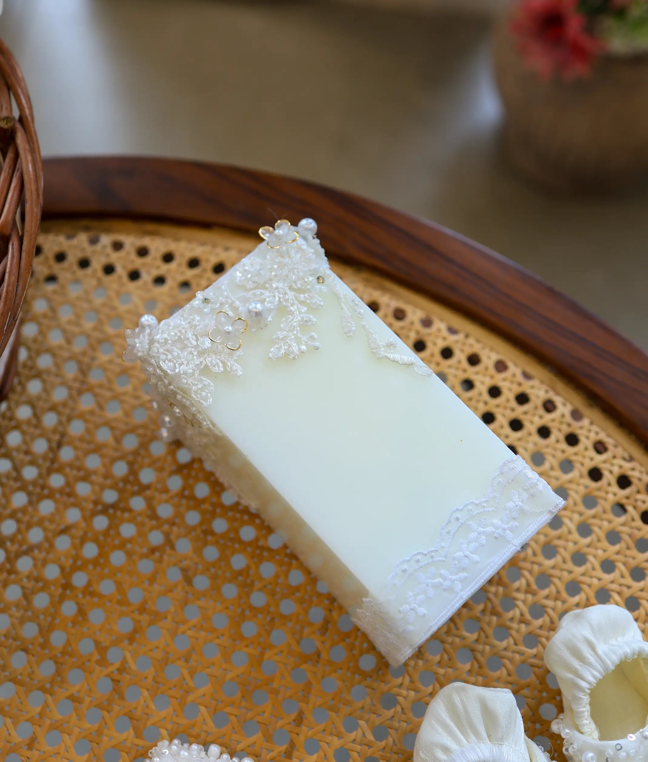 Rectangular off-white baptism candle decorated with delicate lace trim, pearl clusters, and floral embroidery.