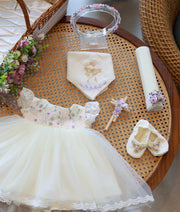 Complete off-white handworked baptism set for baby girl featuring frock, booties, floral headband, decorated candle, cross, and angel embroidered handkerchief.