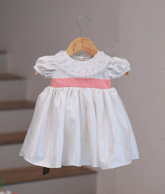 Off-white handworked baptism frock for baby girl with detailed floral embroidery and a voluminous layered net skirt
