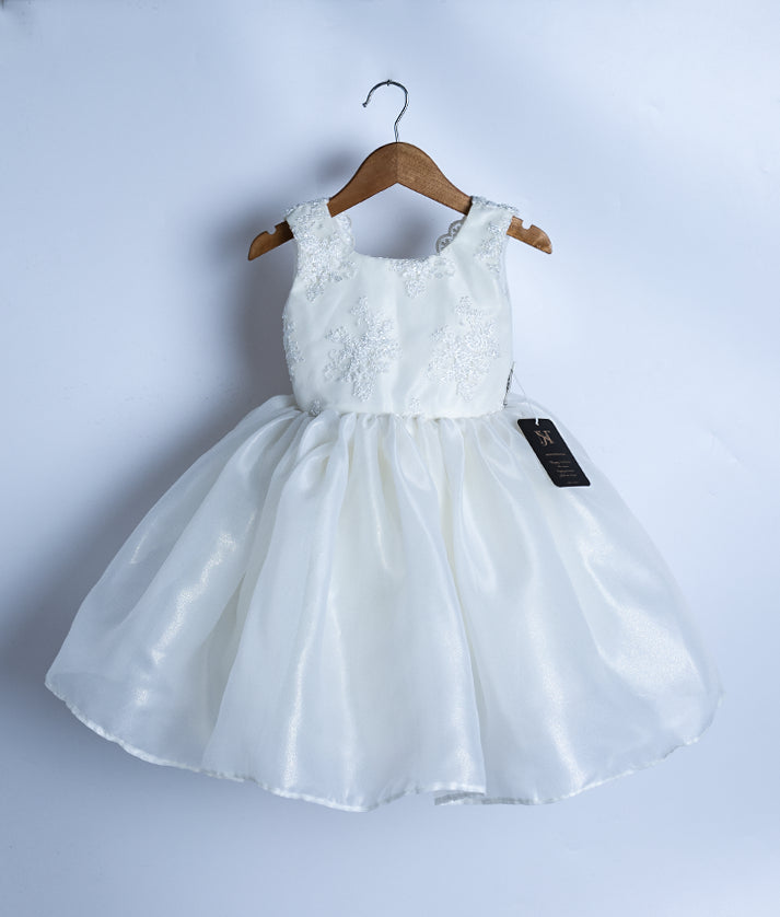 Front view of an off-white shimmer organza birthday frock for baby girls with floral embroidery and flared skirt