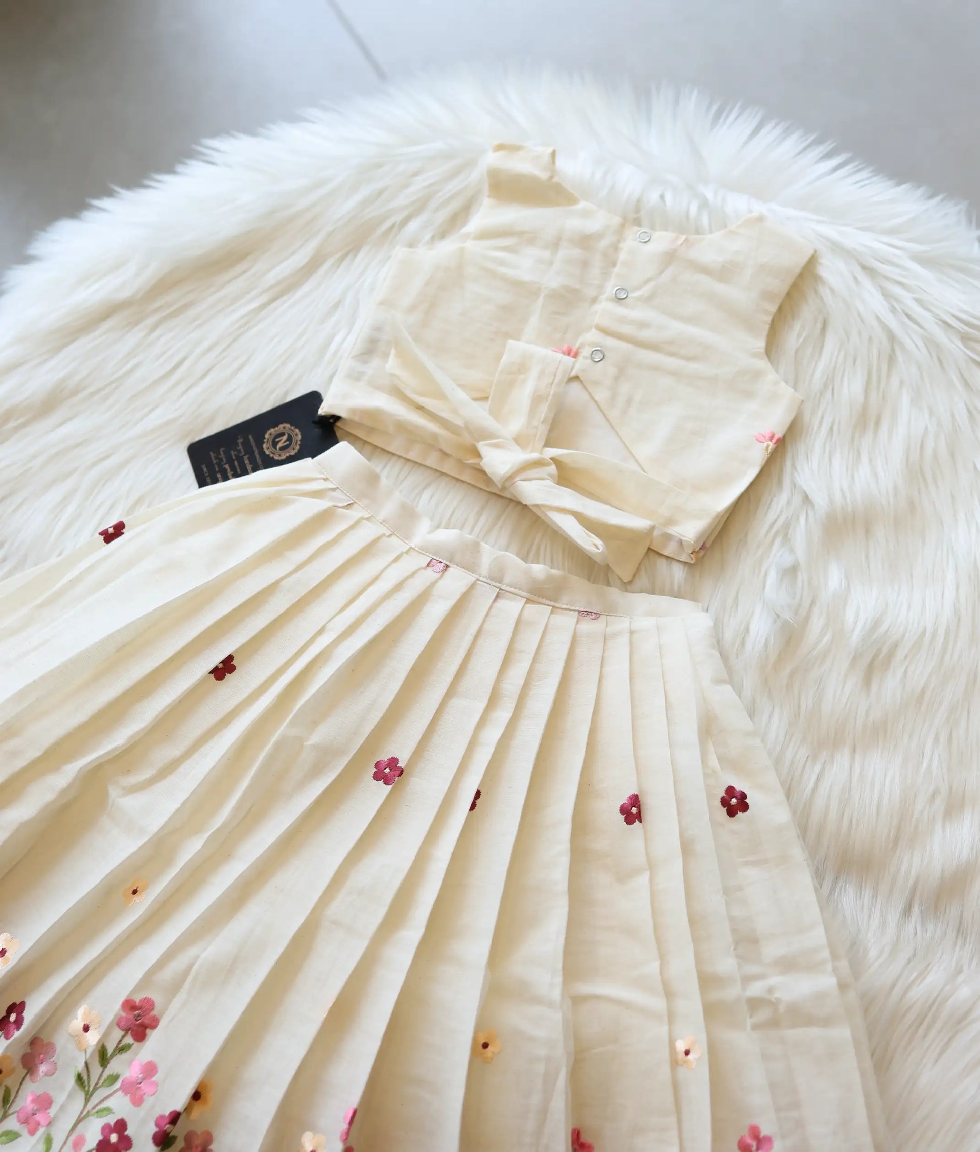 Back view of the off-white top showing the secure button closures.