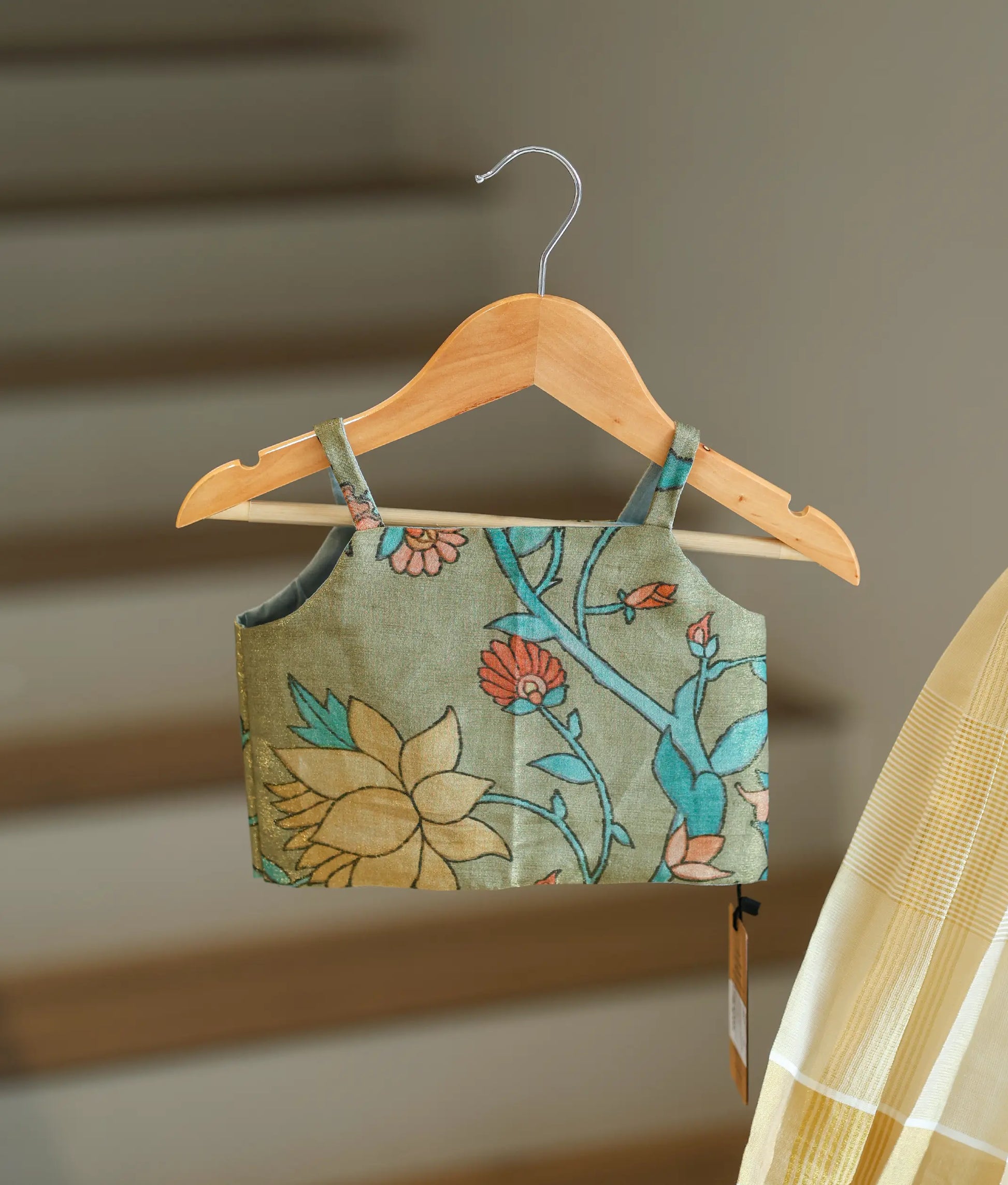 Close-up showing the colorful floral pattern on the green top.