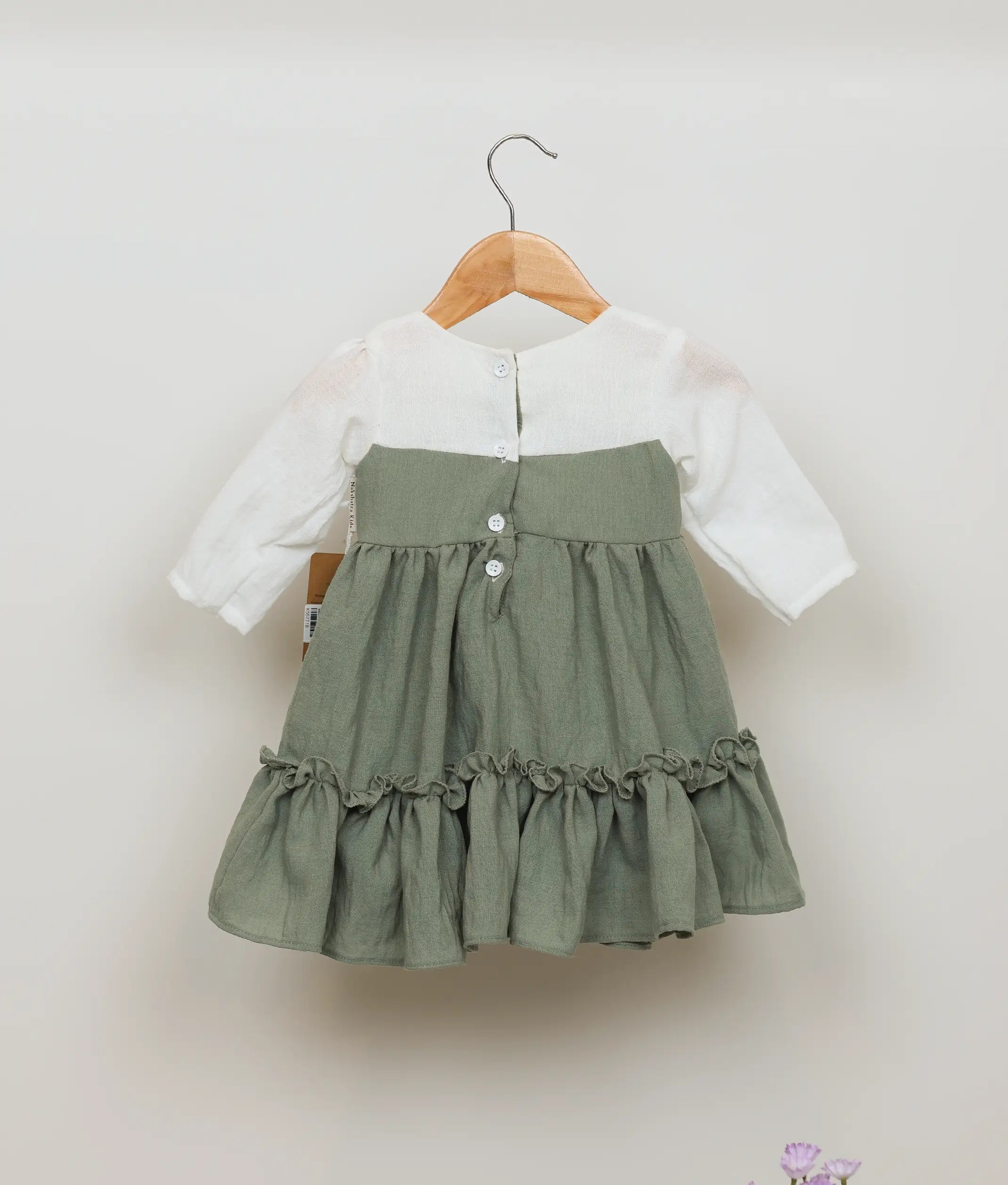 Back view of an green linen floral embroidery christmas frock for bay girls.