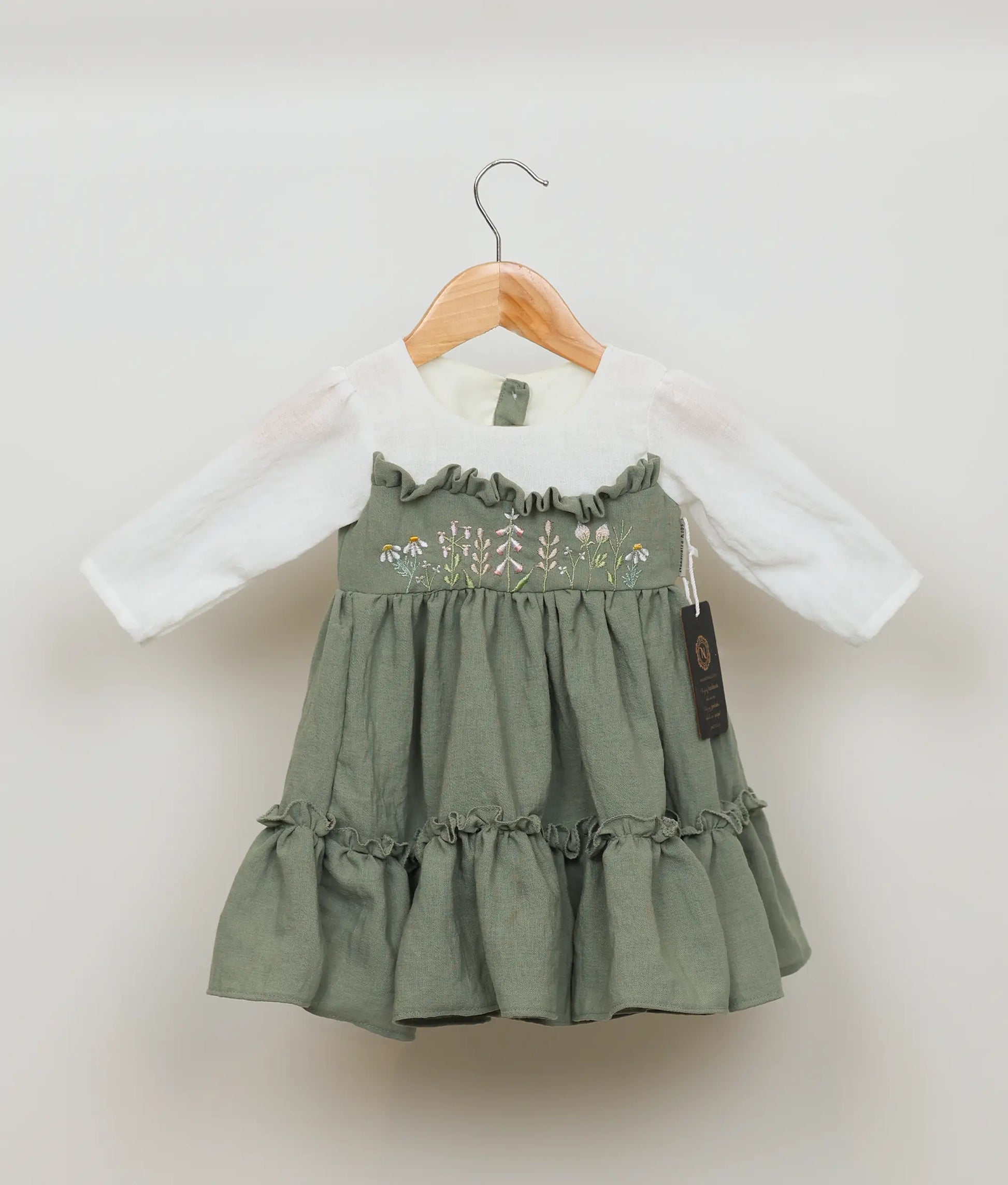 Olive green linen frock with peasant sleeves and delicate floral embroidery for baby girls.