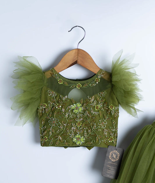 Close-up of olive green swan theme dress showing handmade applique work and embroidered bodice skirt for baby girl