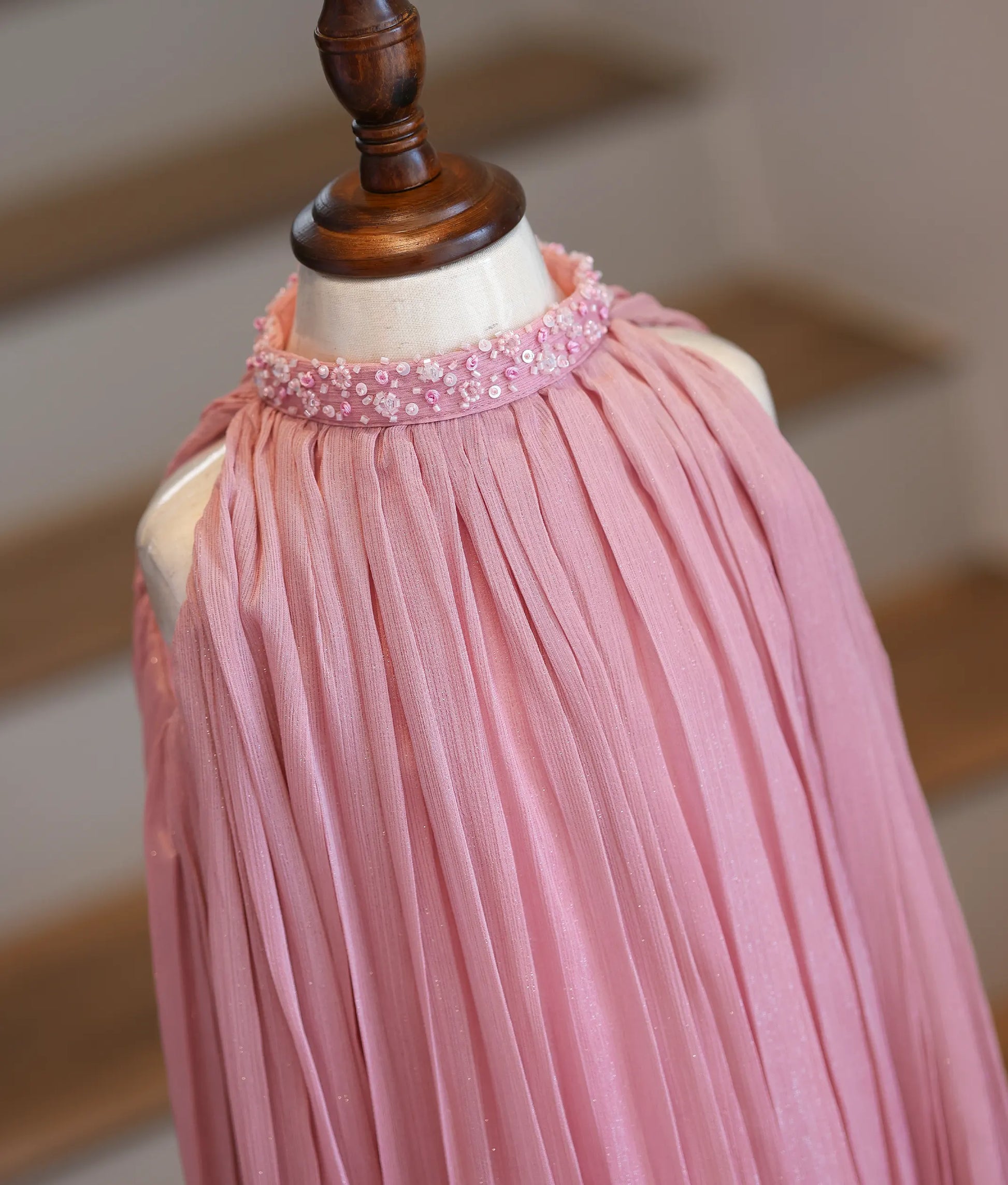 Close-up of the hand-embedded beads and sequins on the high-neck collar and the micro-pleated shimmer georgette fabric.