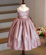 Front view of an onion pink milan foil birthday gown for baby girls featuring thin shoulder straps, square-neckline, and a pleated flared skirt