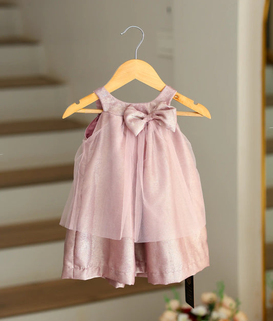 Front view of a onion pink organza birthday frock with a bown for baby girls with floral sequin designs