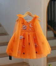 Front view of bright orange galaxy theme handwork tulle net baby girl frock on hanger.