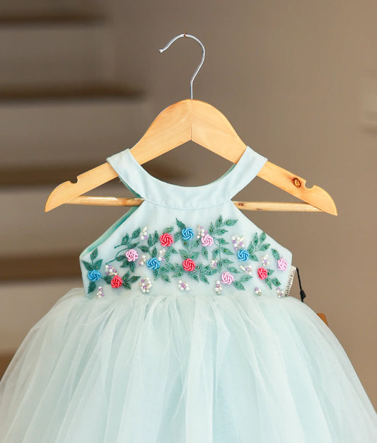 Close-up of the pastel blue frock highlighting the intricate floral embroidery and beadwork on the halter neckline.