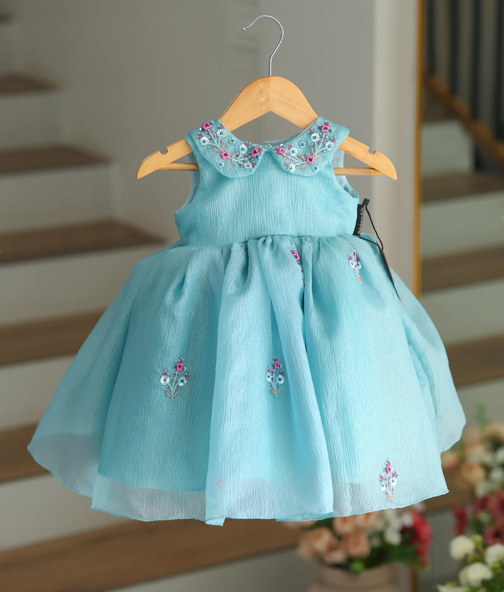 Front view of a pastel green crush organza frock with a handworked Peter Pan collar.