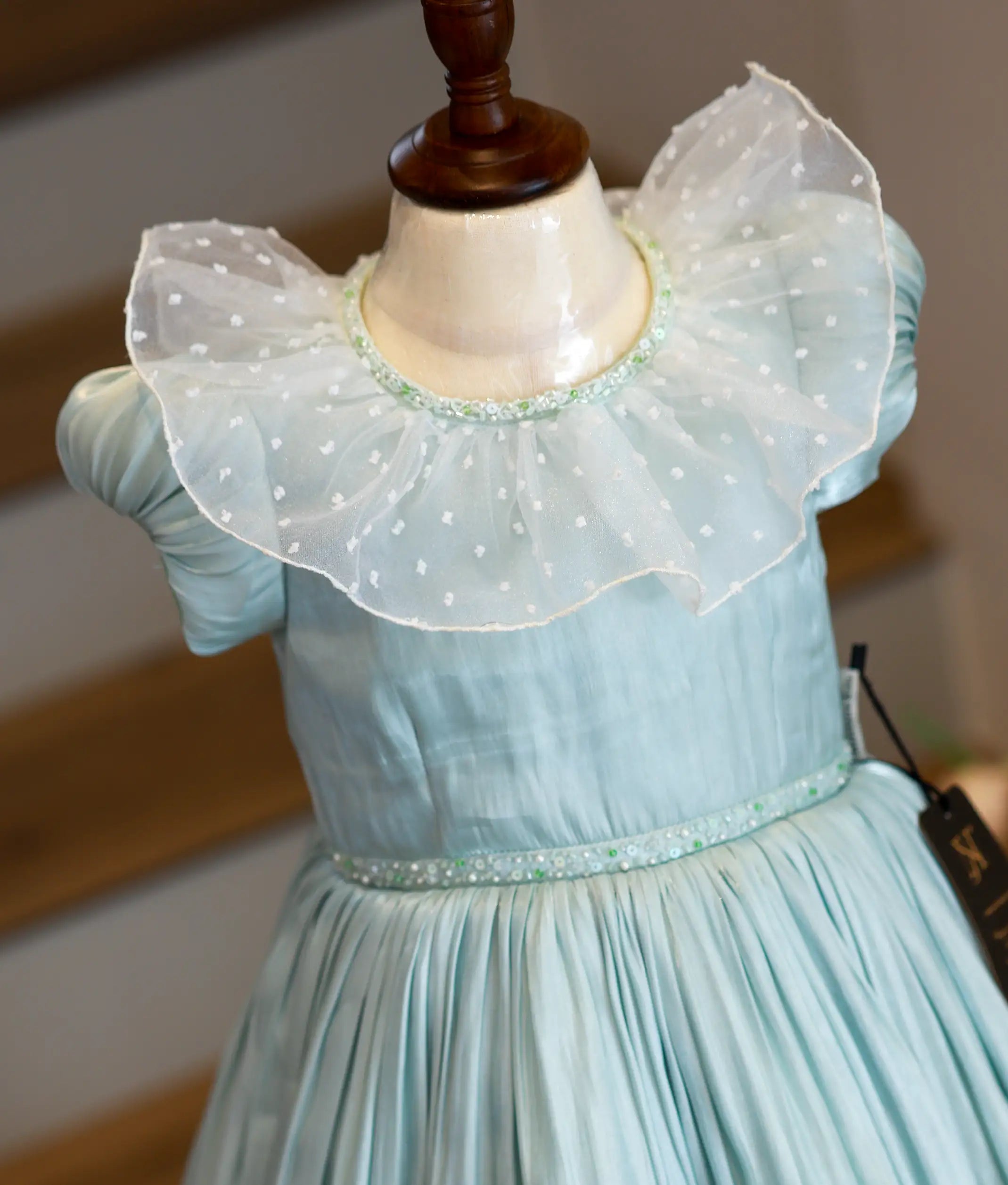 Close-up of the exquisite handwork on the yoke of gown, featuring pearls, sugar beads, and crystals on pastel green laser organza