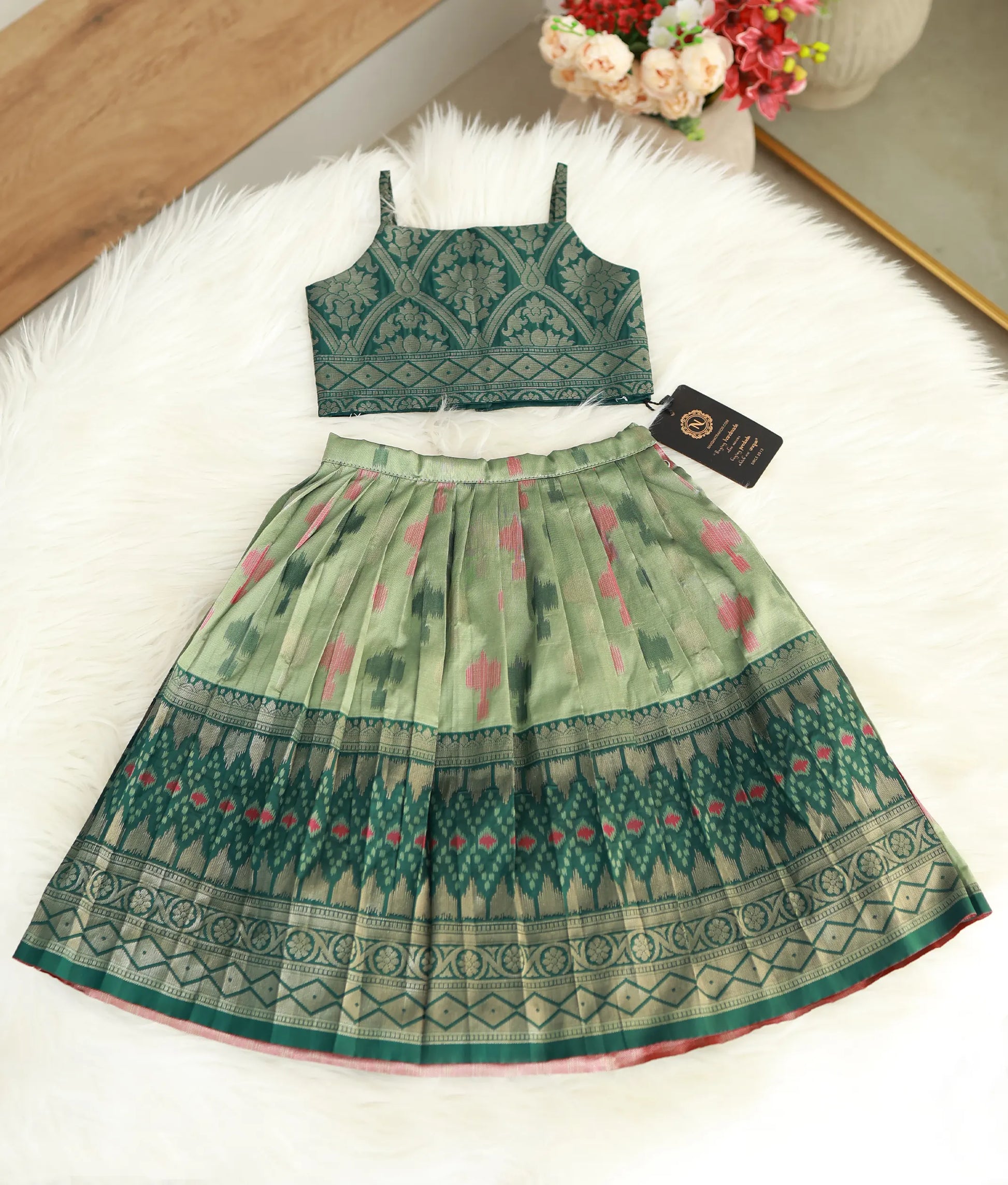 Front view of a traditional emerald green and pastel green Kanchipuram silk skirt and top set.