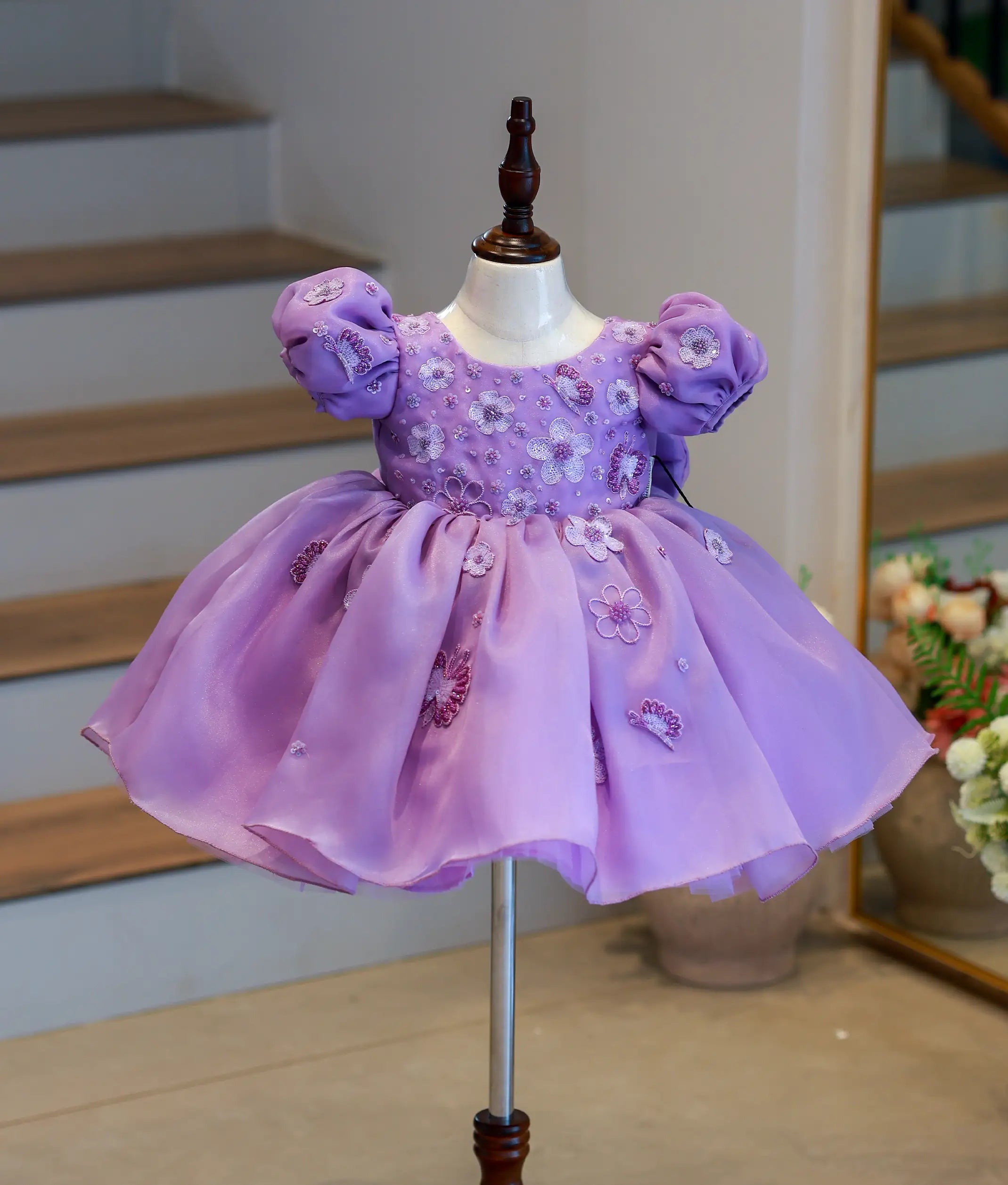 Front view of a pastel lavender flower theme organza birthday frock for girls with floral handwork