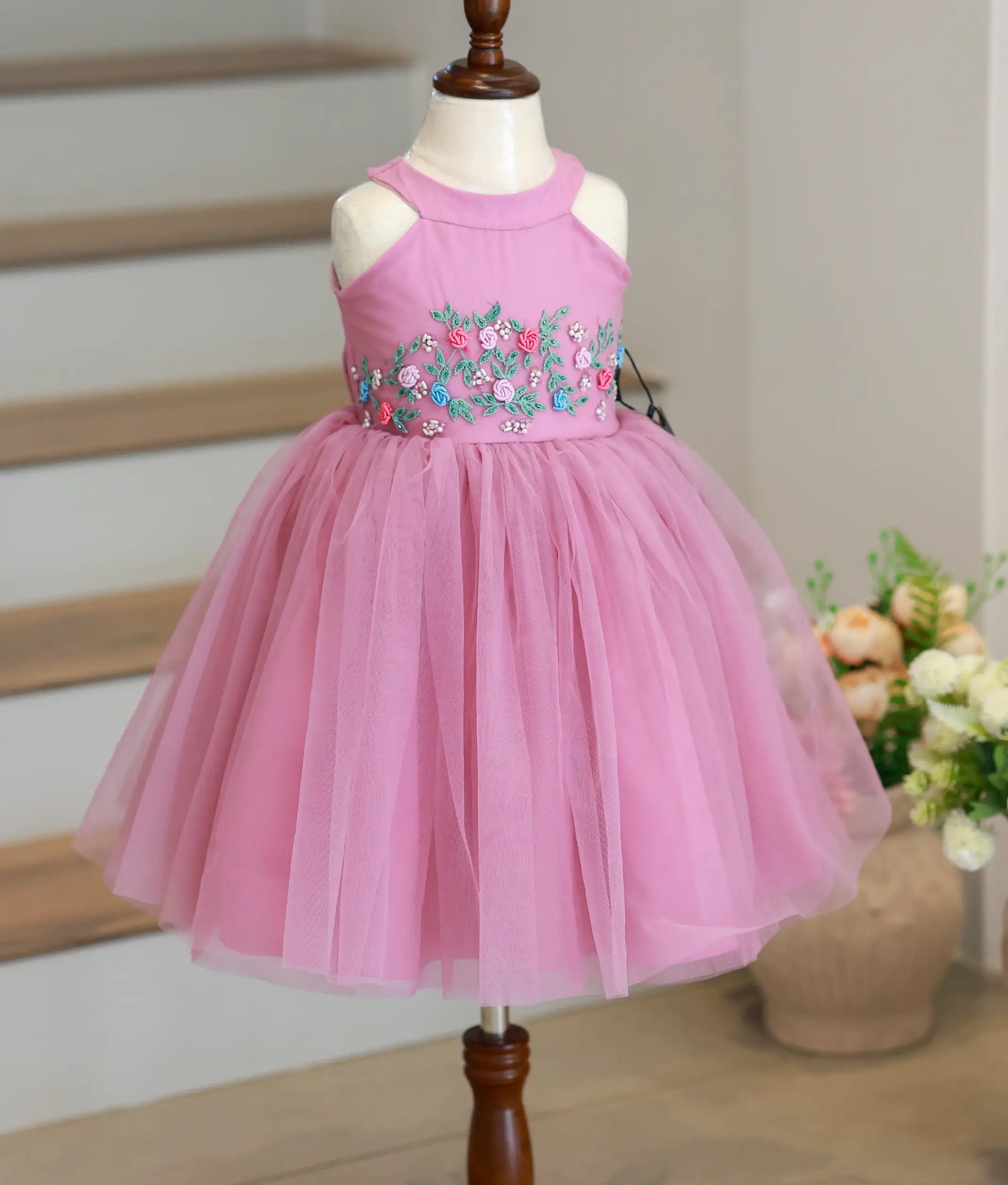 Full front view of a pastel lavender below-knee-length birthday frock featuring a halter neck and handworked bodice.