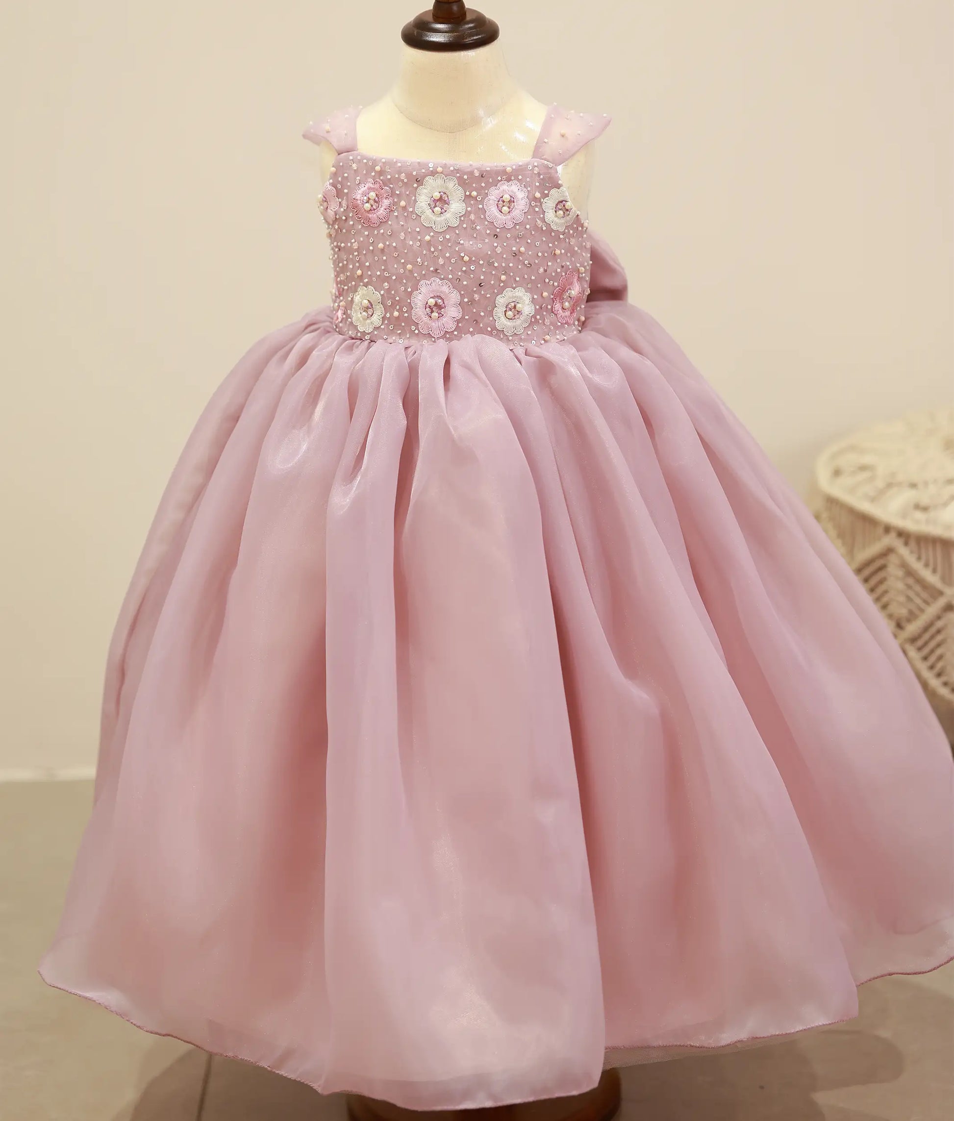 Front view of a pastel lavender satin organza handwork gown for baby girls with a voluminous layered skirt