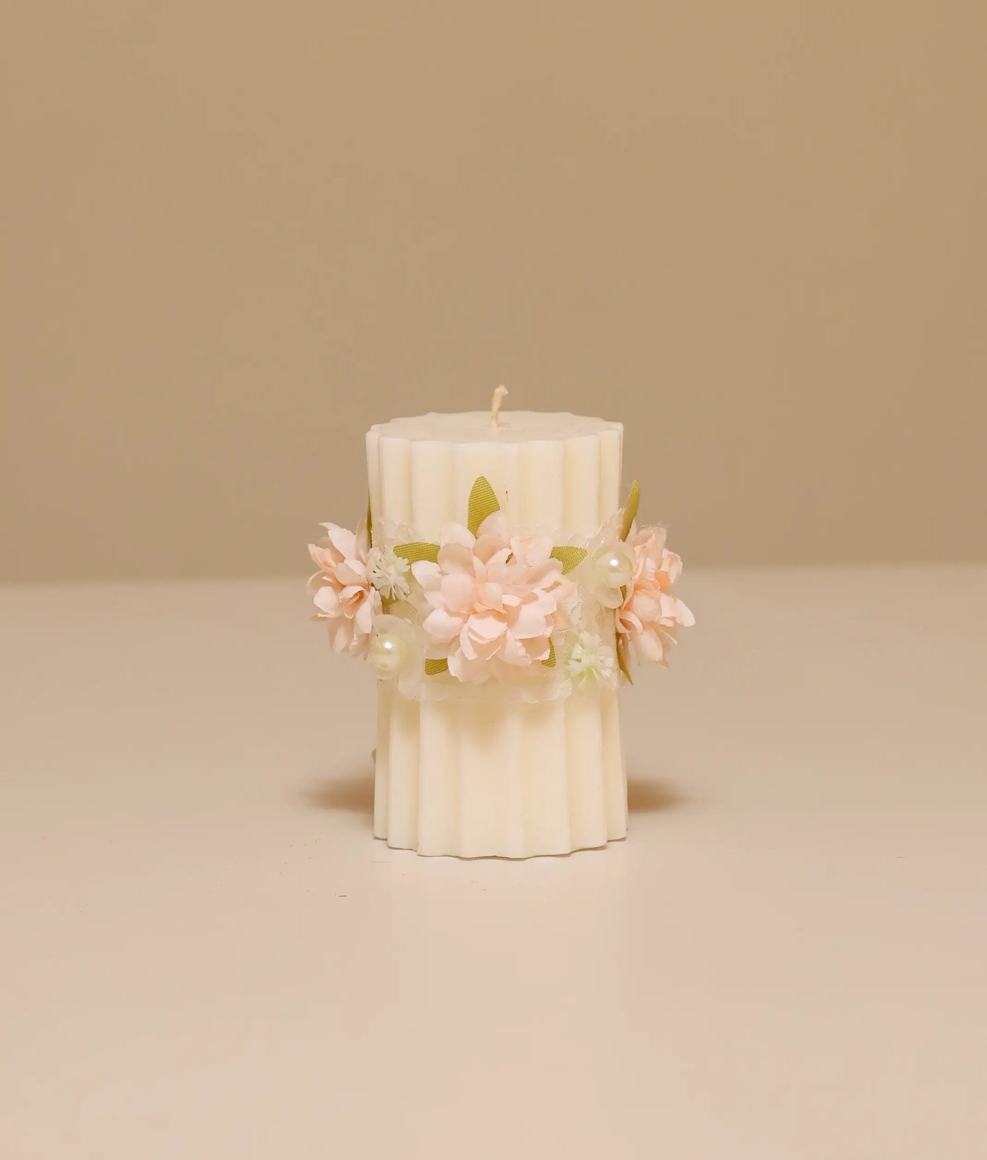 Peach floral pillar baptism candle for baby girl featuring silk flowers, white lace ruffles, and gold pearl accents