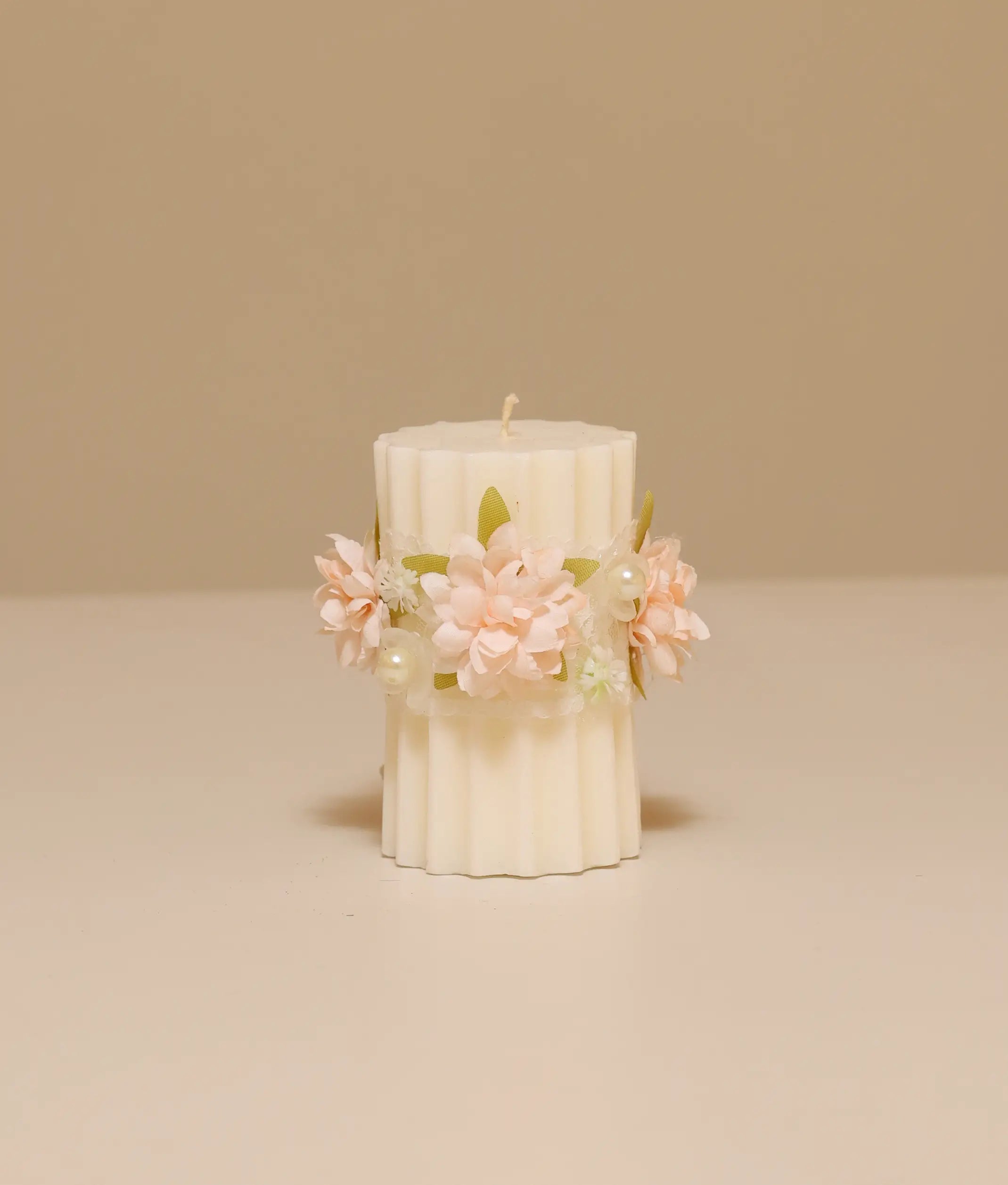 Peach floral pillar baptism candle for baby girl featuring silk flowers, white lace ruffles, and gold pearl accents