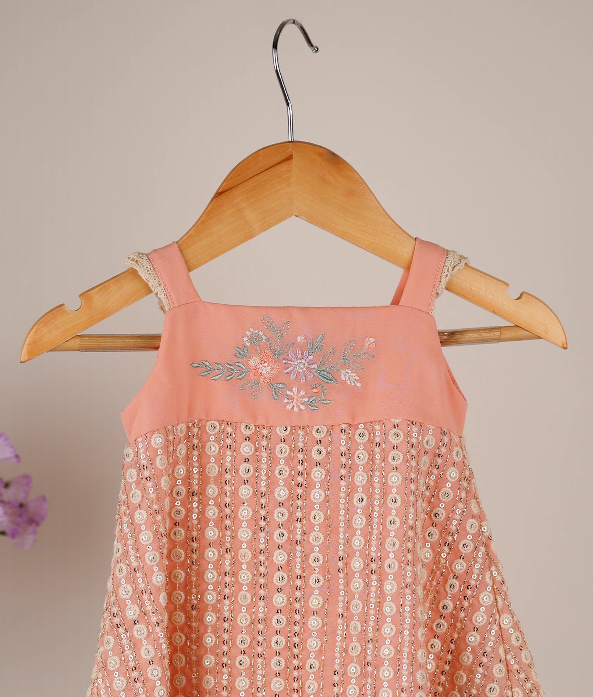 Close-up of the peach frock showing the machine embroidery on the top and Crosio lace on the sleeves