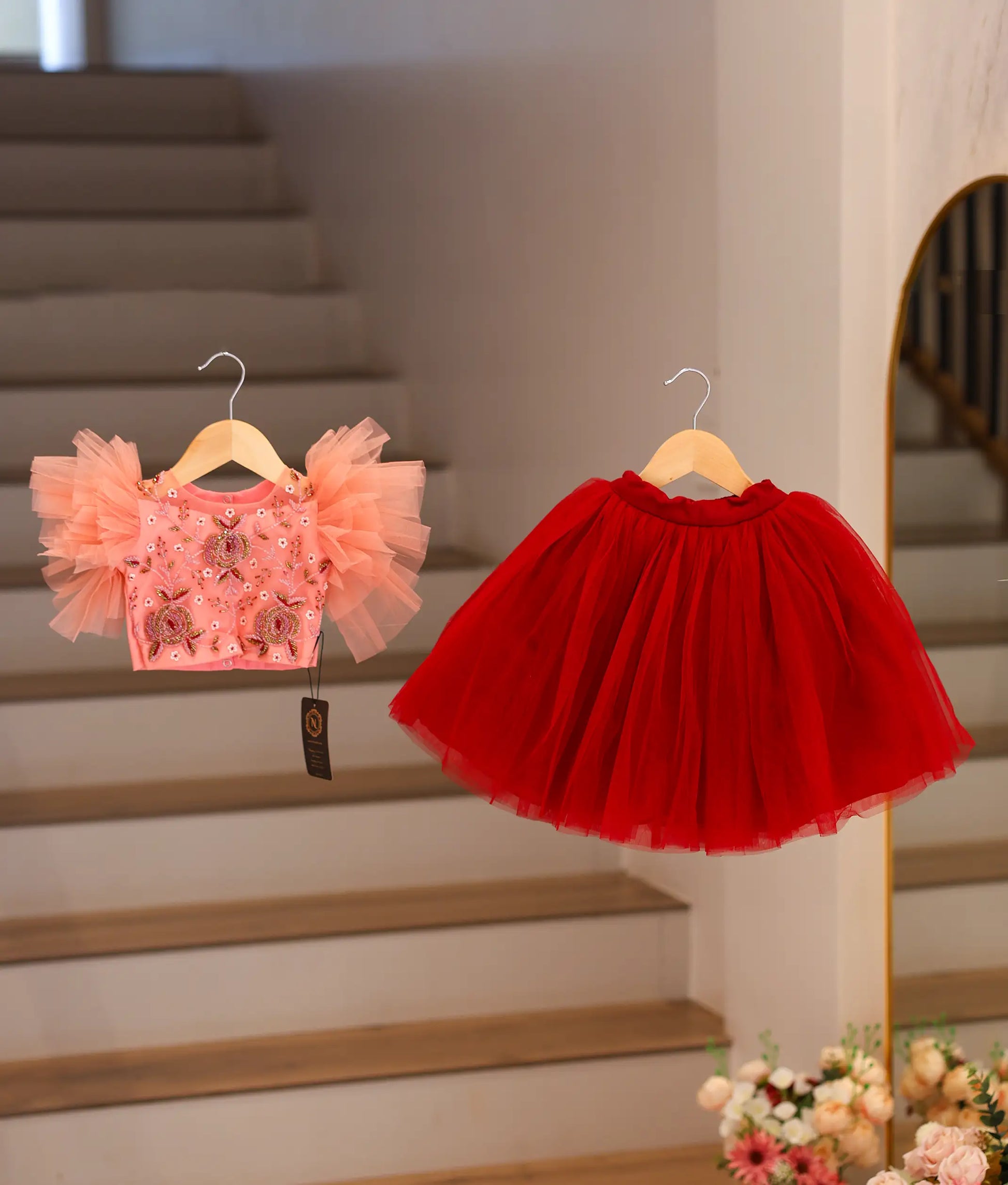 Peach handworked crop top and a maroon full-length net skirt with scalloped edges