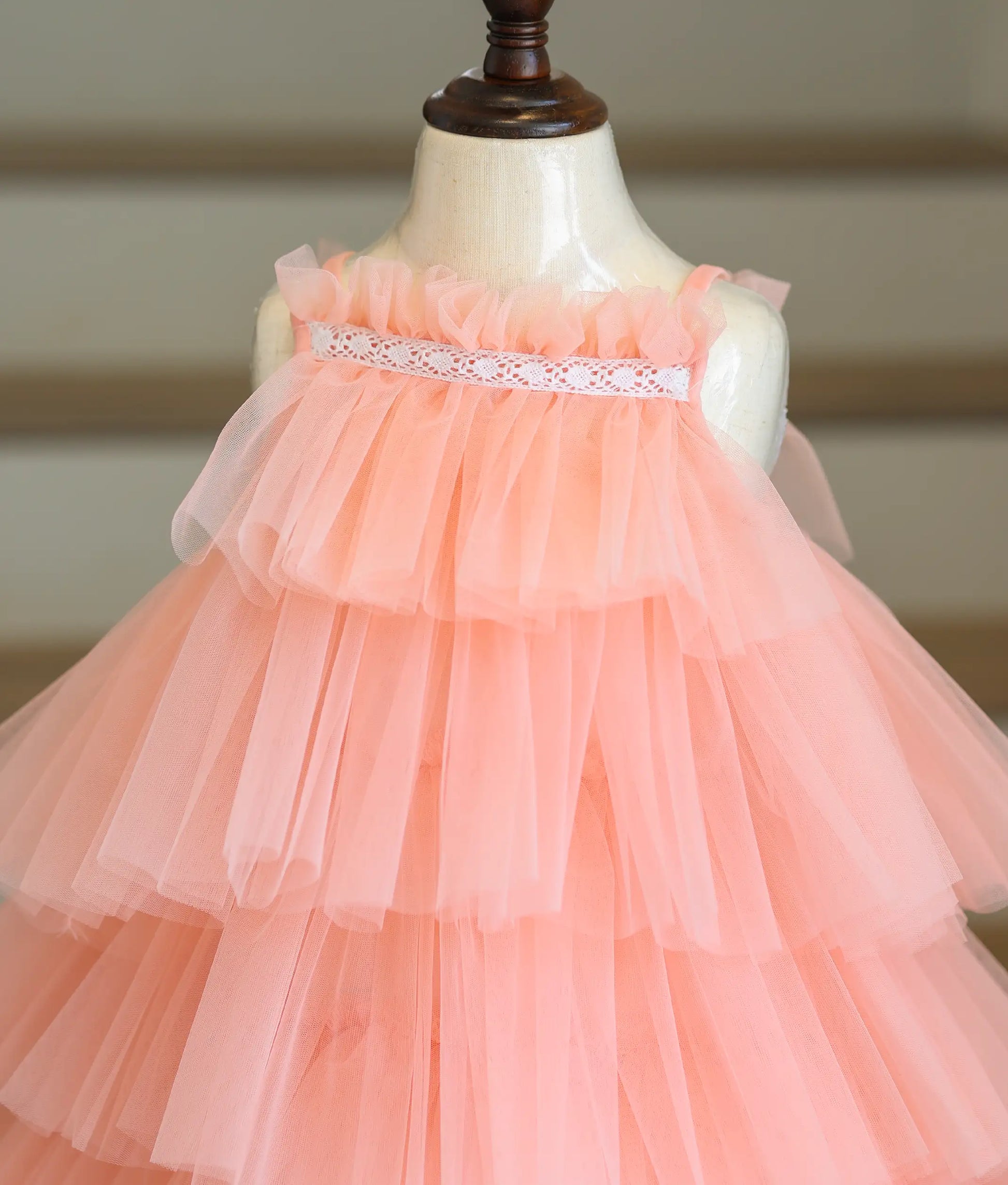 Close-up of the lace detailing and step-pattern tulle net layers on the top of the birthday frock.