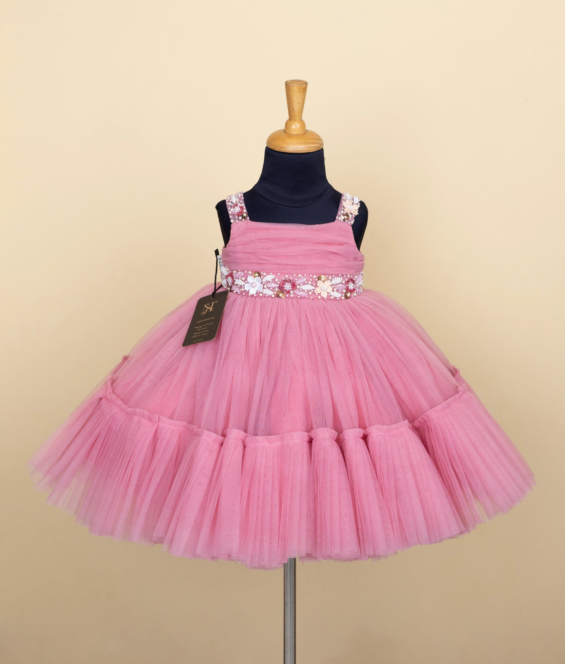 Front view of pink birthday frock for baby girl with floral waist belt – Versatile Fashion