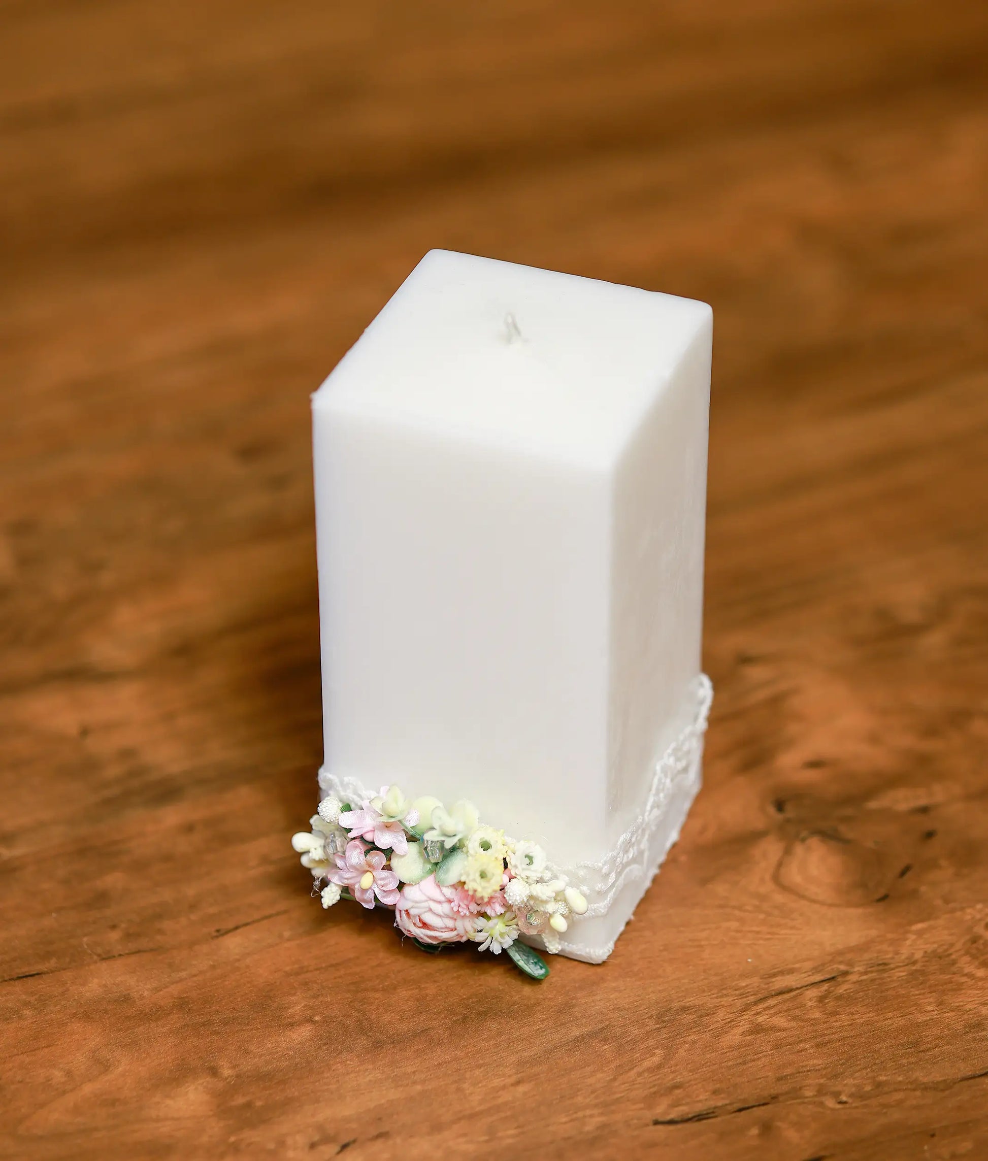 Close-up of the handcrafted pink roses and shimmering pearl accents on the decorative baptism candle