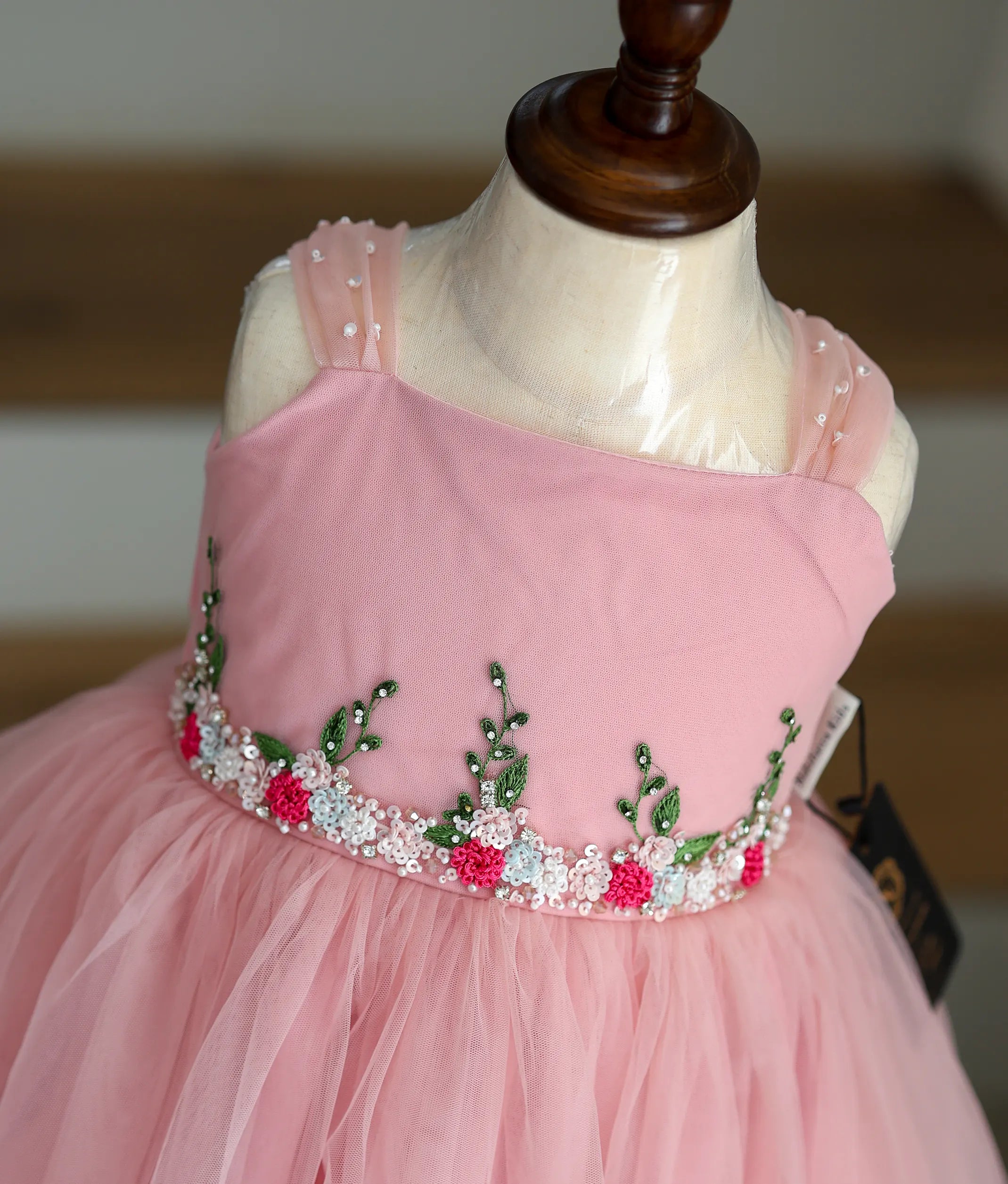 Close-up of the beautiful bead and thread handwork on the pink frock top.