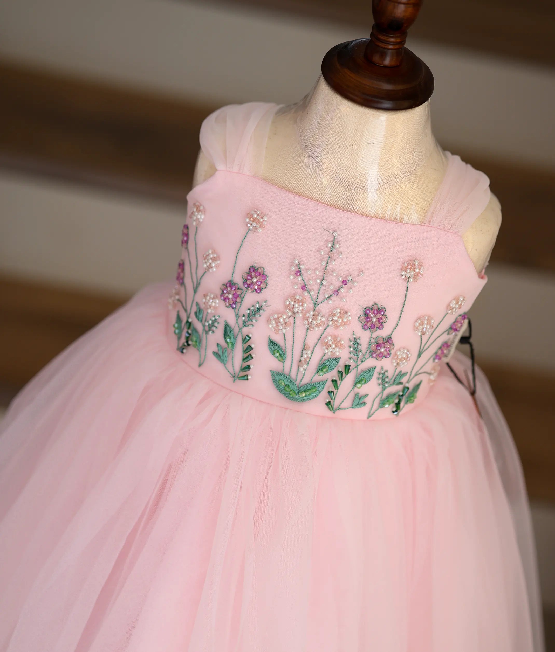 Close-up of the beautiful bead and thread handwork on the pink frock top.