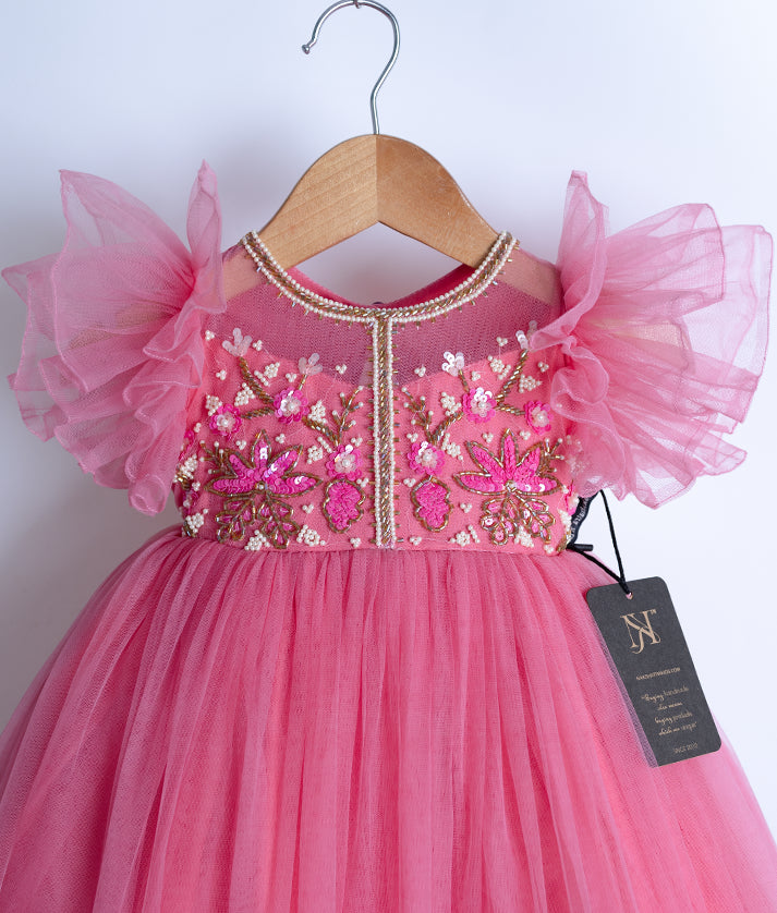Close-up of the glittering handwork on the bodice and the ruffled edge of the butterfly sleeves.