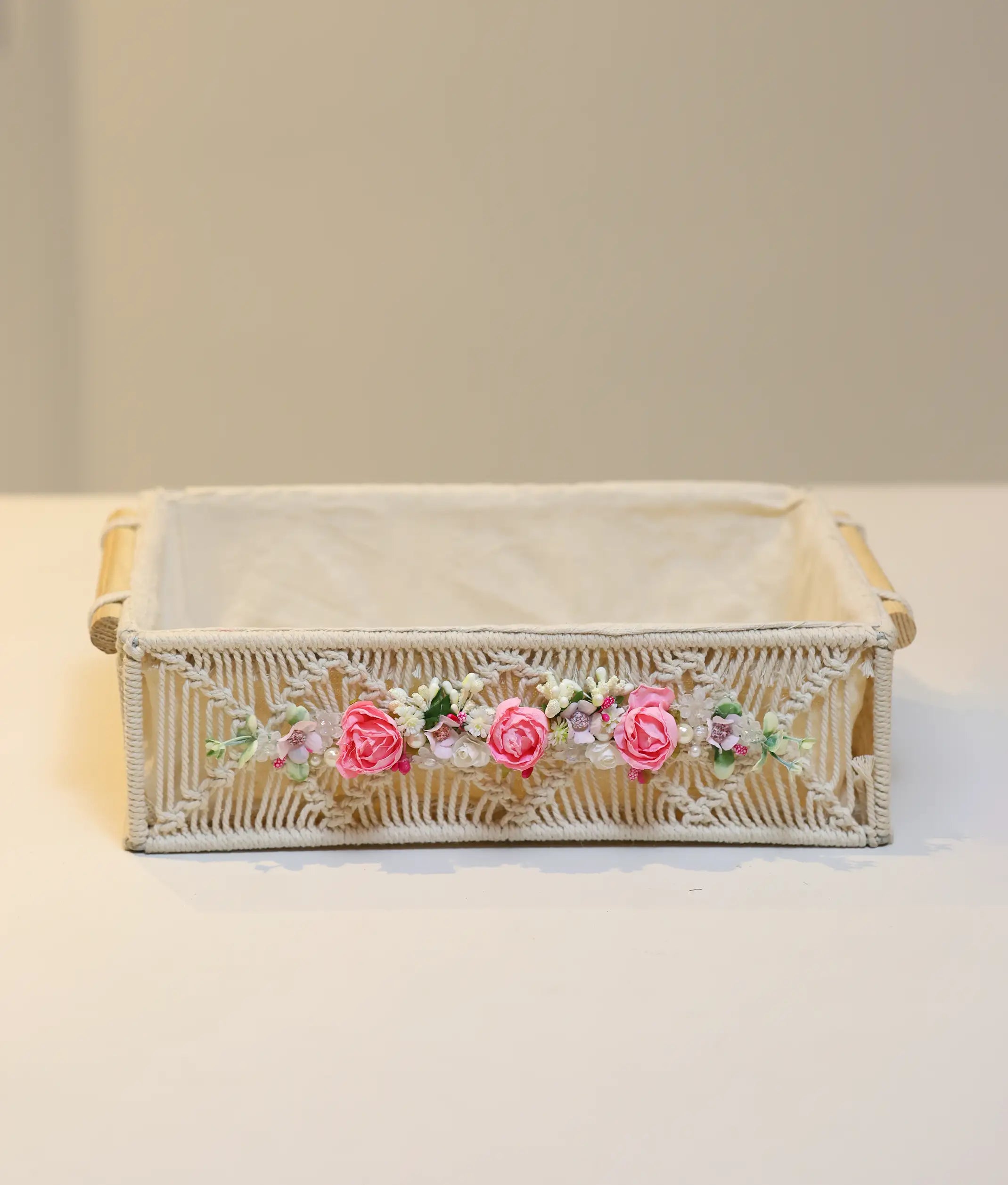 Hand-decorated pink baptism basket for baby girl featuring white lace, silk flowers, and premium fabric lining