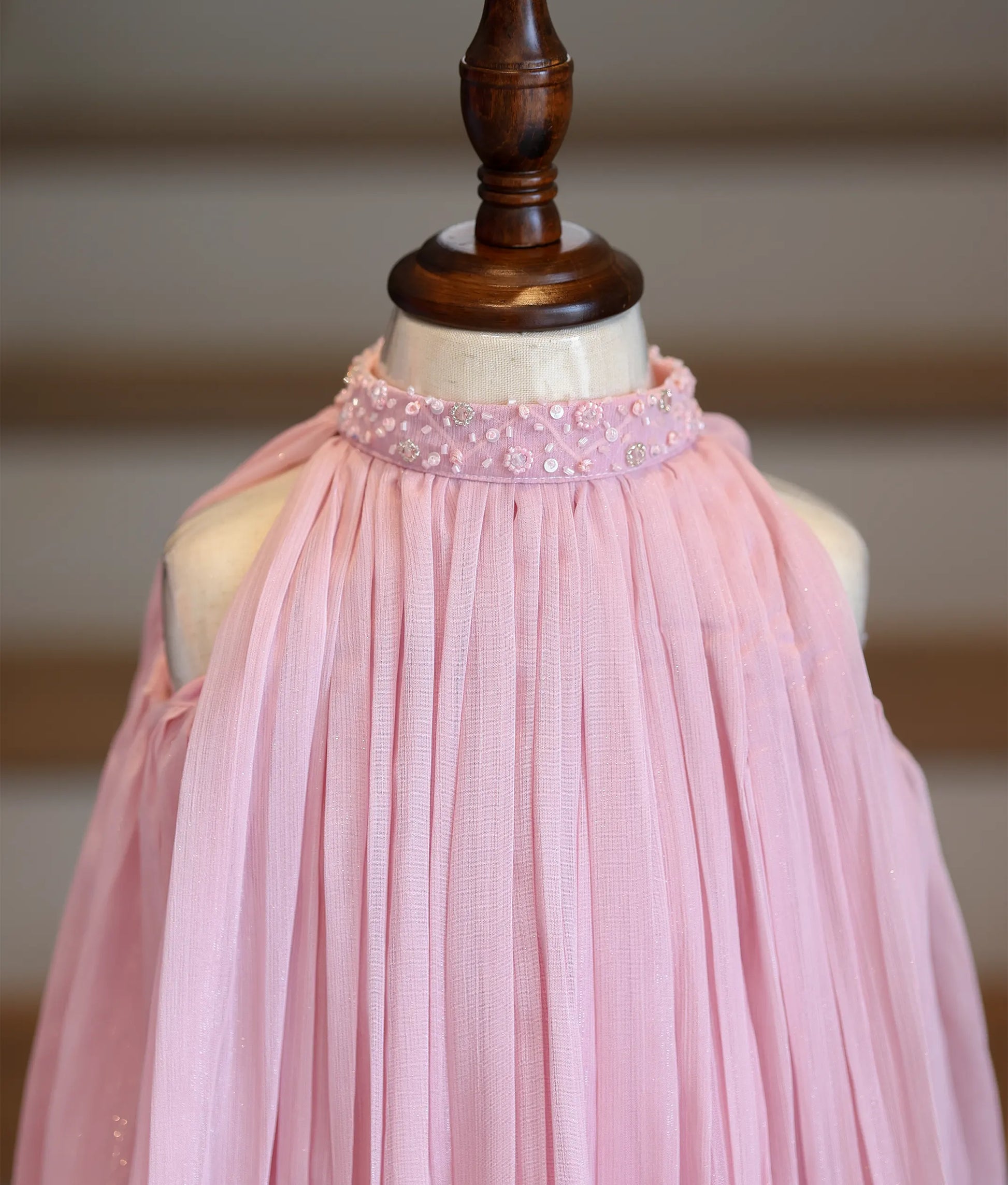 Close-up of the hand-embedded beads and sequins on the high-neck collar and the micro-pleated shimmer georgette fabric.