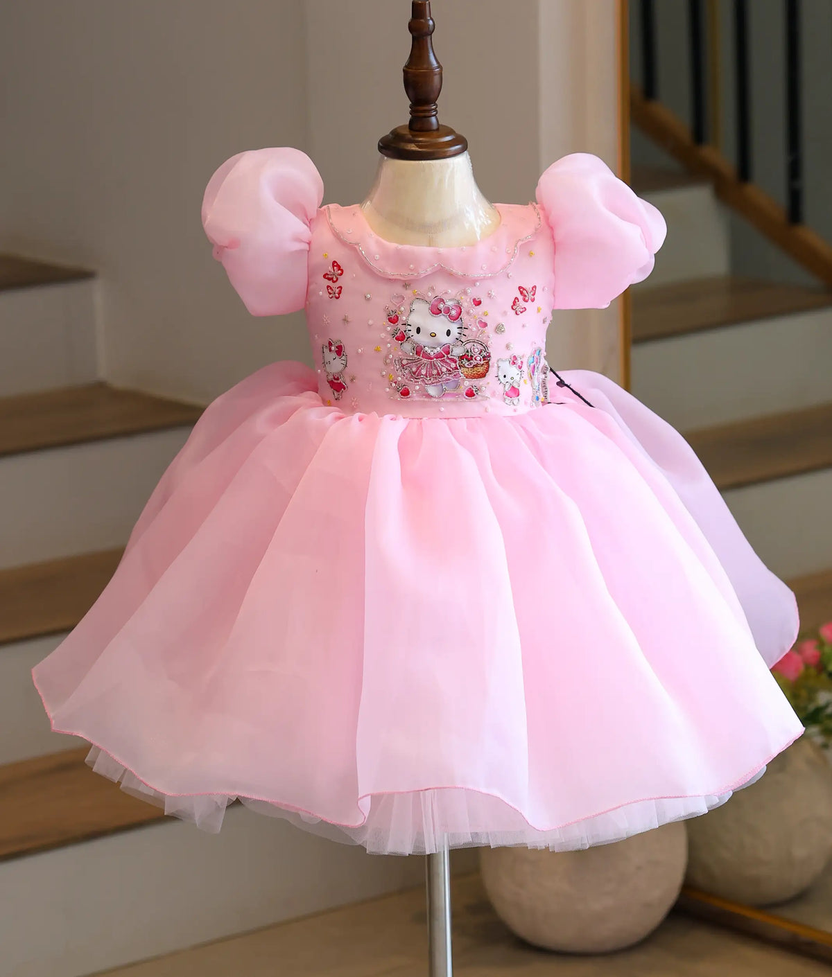 Front view of pink Hello Kitty-themed handworked plain organza girls' frock